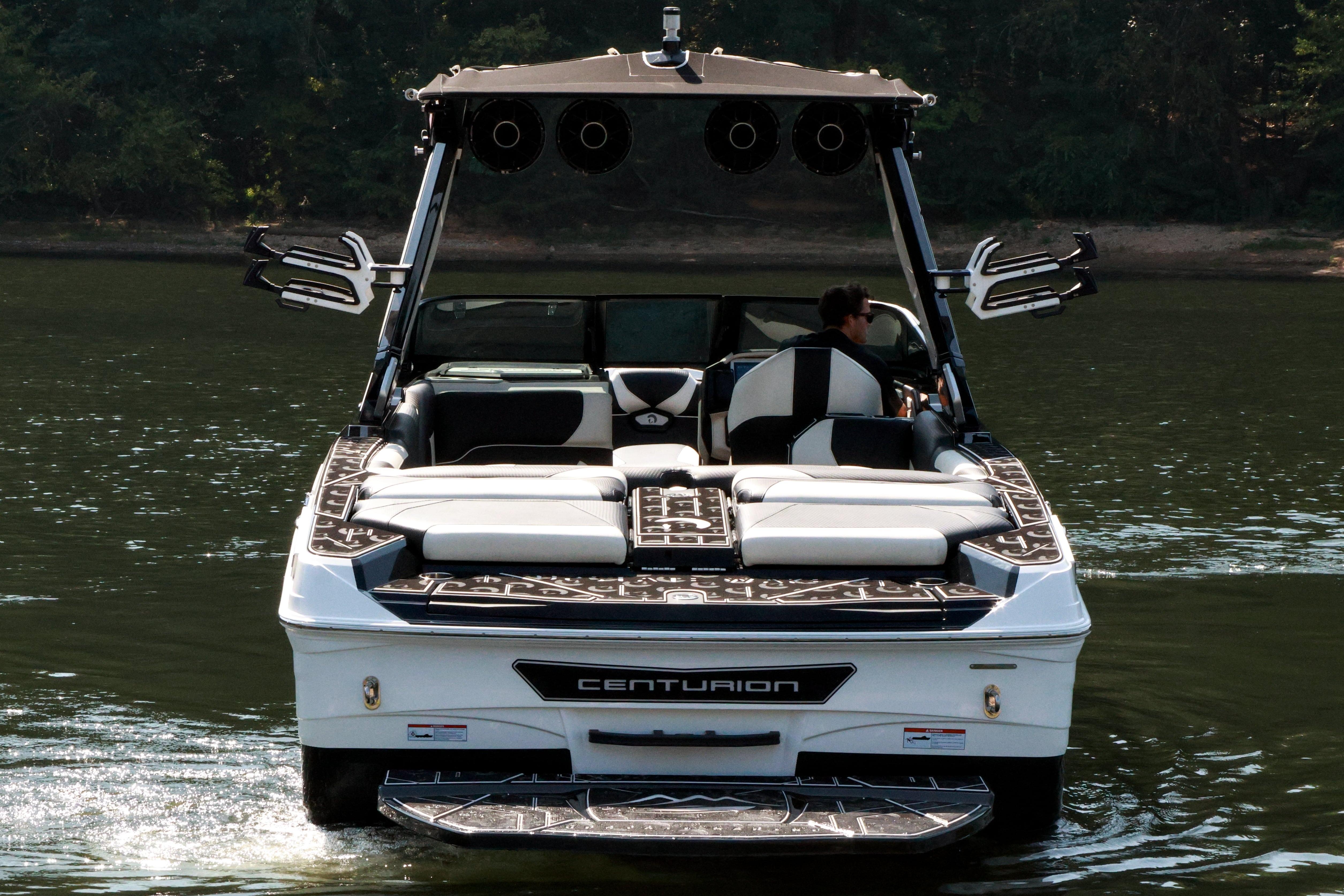 2022 Centurion Ri265 boat cruising on a calm lake.