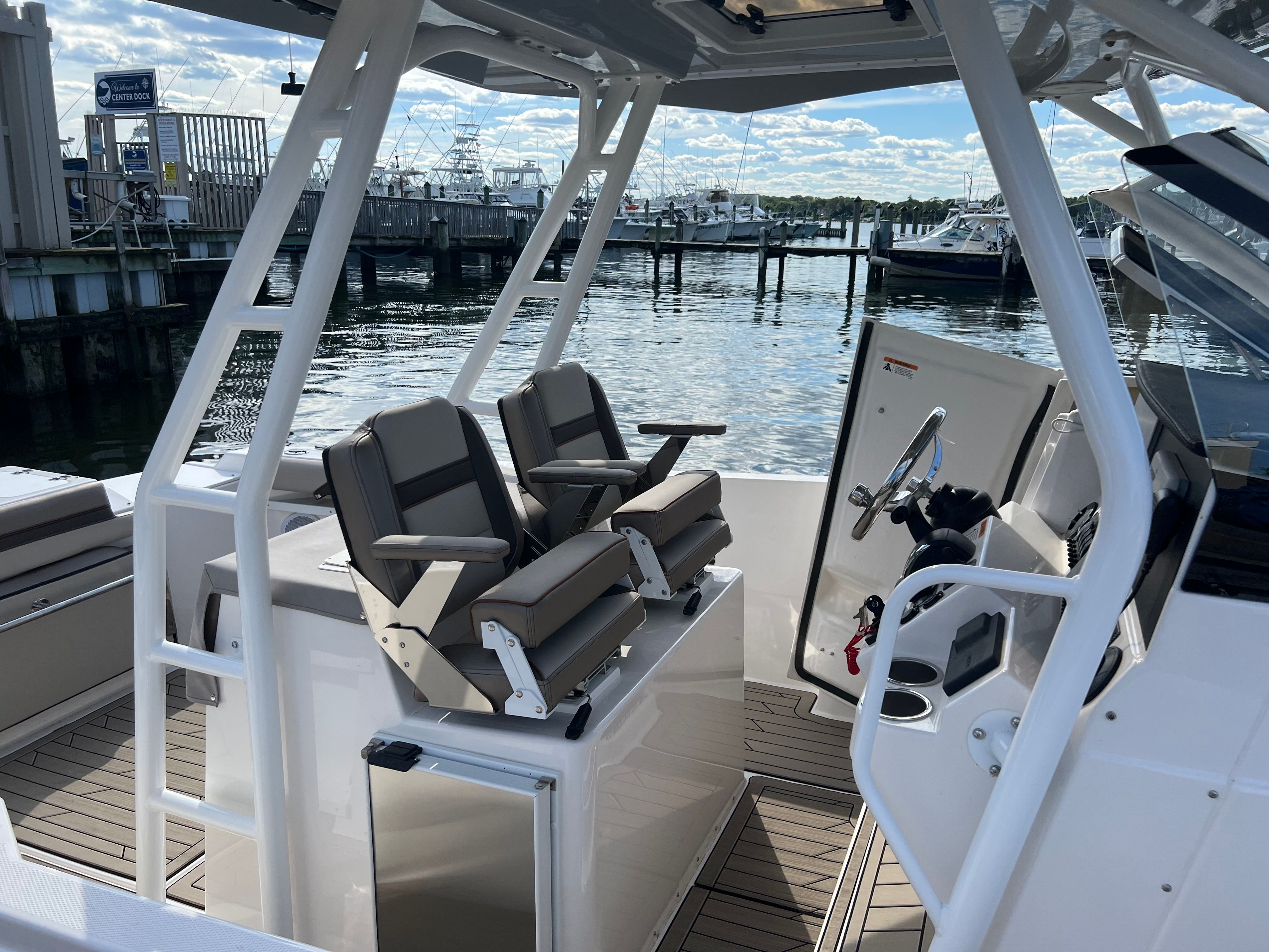 The image shows the cockpit of a 2022 Cutwater C-24 CW with two cushioned seats.