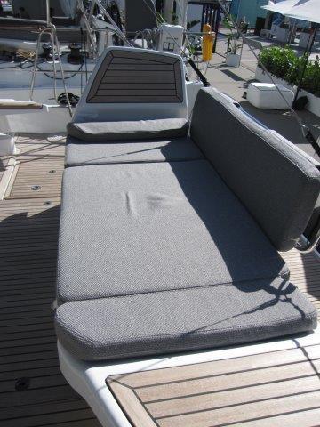 2025 Jeanneau Yacht 65 deck with cushioned seating area.