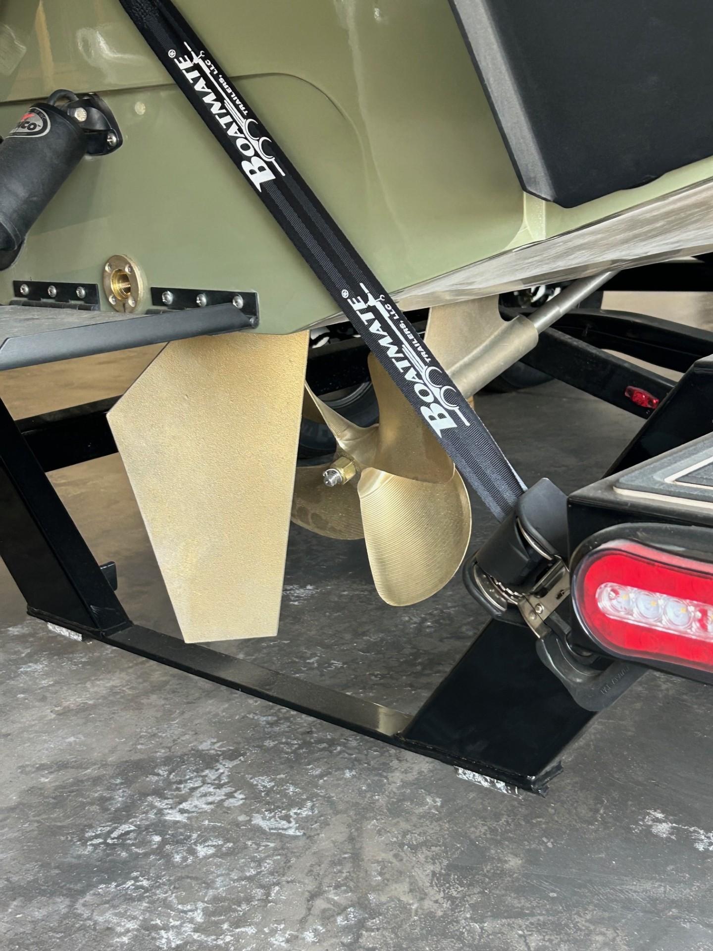 2024 MB F22 Tomcat boat propeller and trailer detail with Boatmate strap.