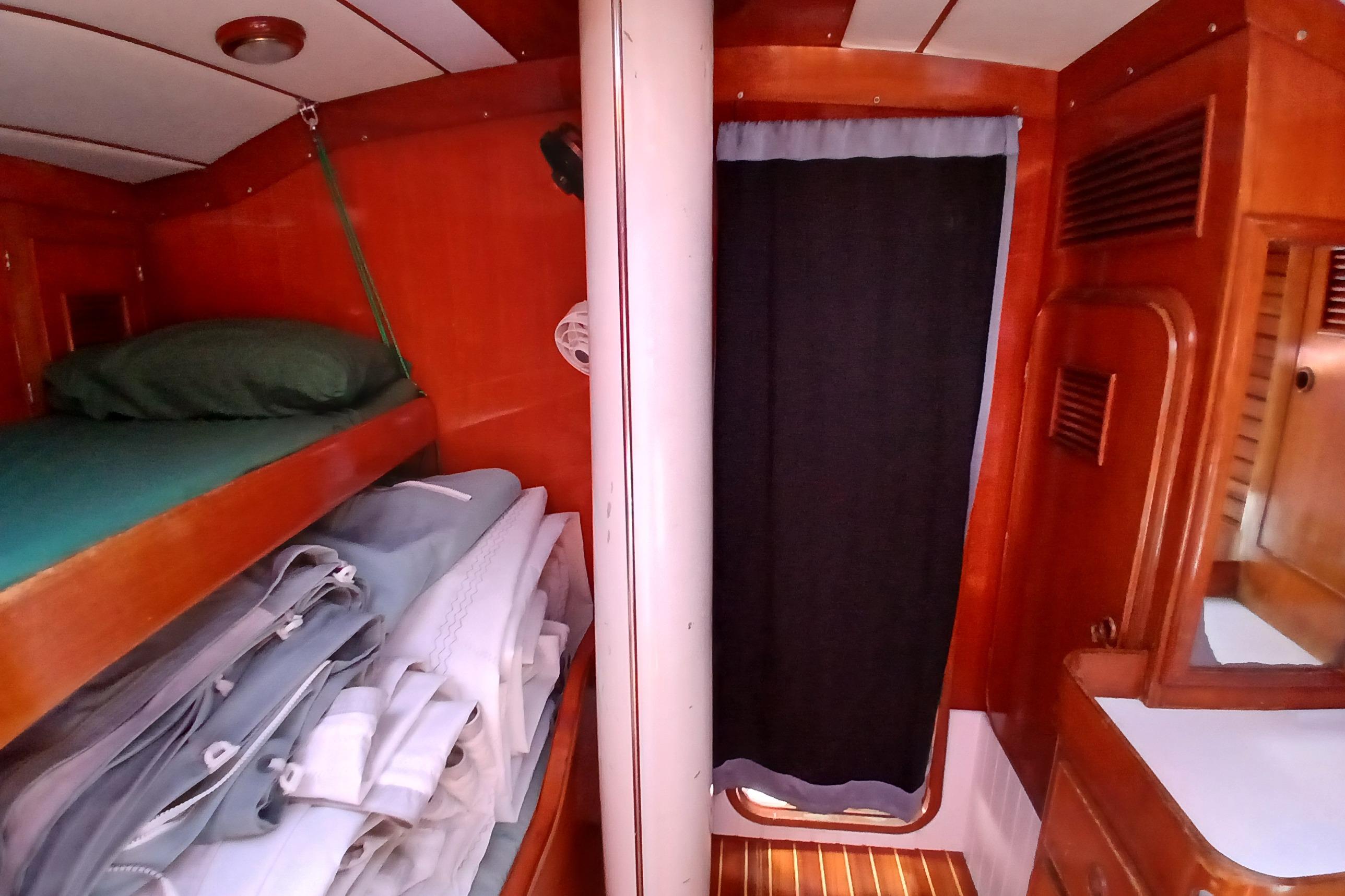Interior of 1981 SKYE 51 sailboat cabin with wooden bunk and storage.