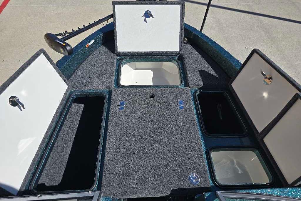 2026 Ranger 212LS boat interior with open storage compartments and carpeted deck.