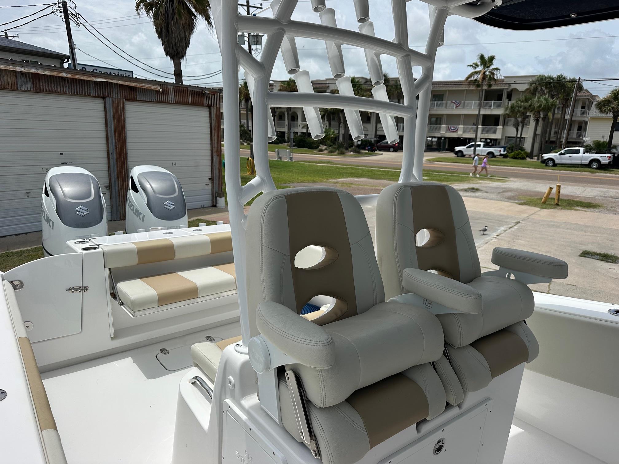 2023 Cape Horn 32xs boat interior with dual seats and Suzuki engines in a coastal setting.