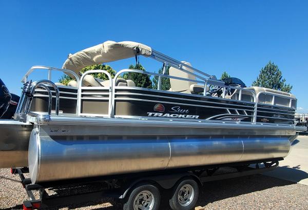 2023 Sun Tracker SportFish 22 XP3 pontoon boat on trailer.