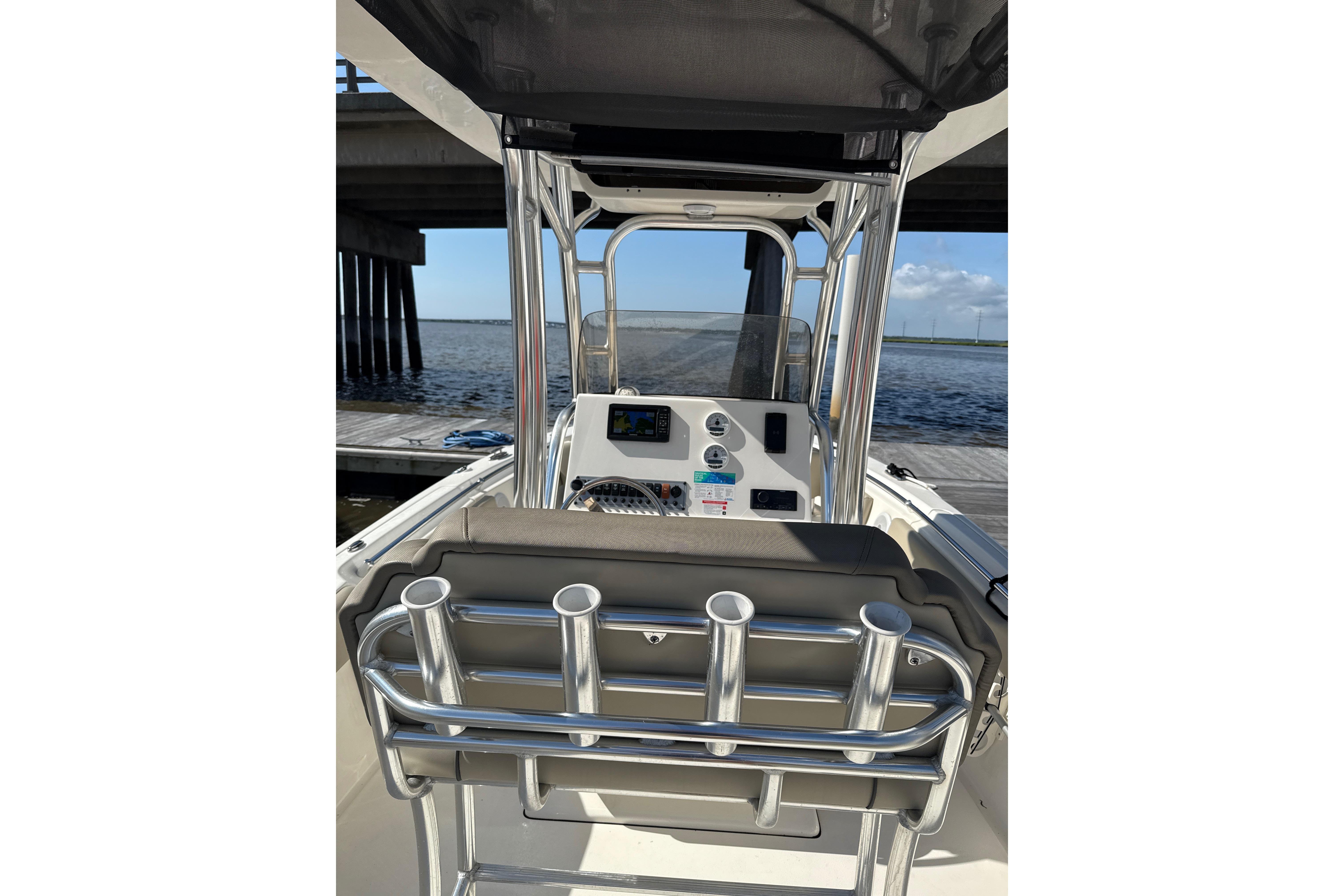 2024 Key West 239 FS boat interior with console and rod holders, docked by water.