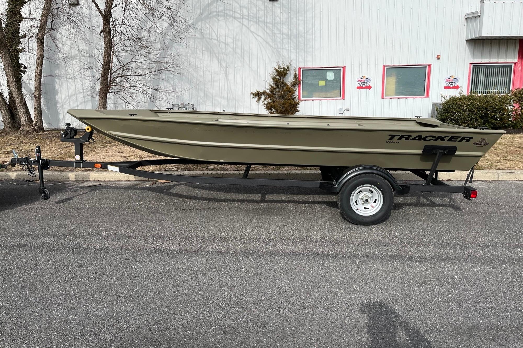 2026 Tracker Grizzly 1754 Utility boat on trailer, parked outdoors.