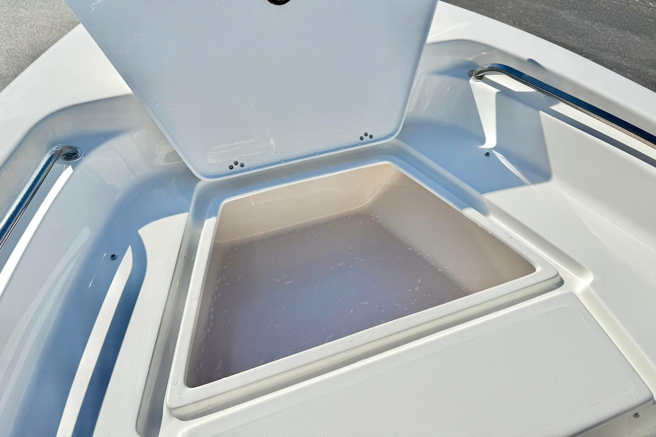 Open storage compartment on 2026 Key West 189 FS boat, featuring sleek white interior design.