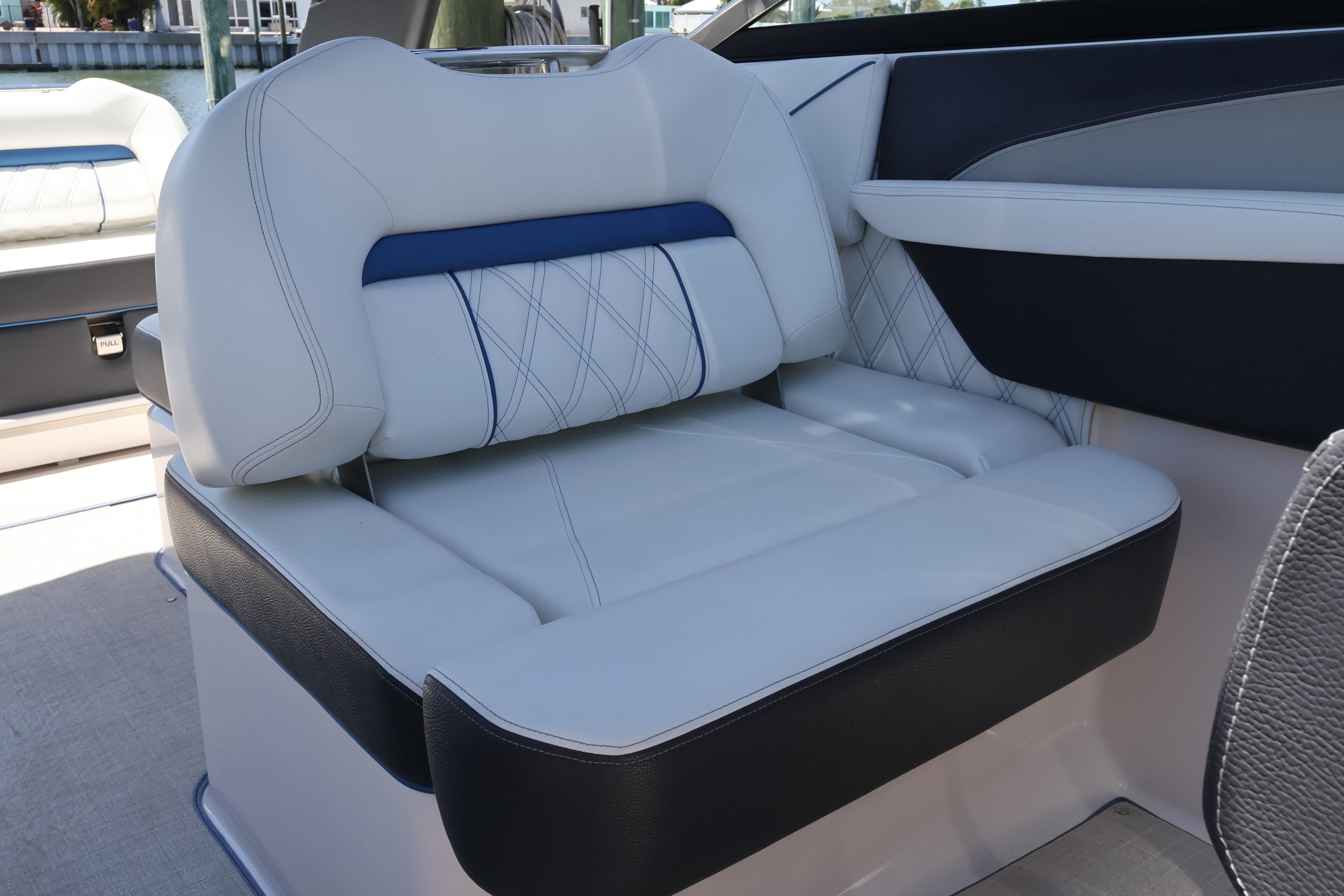Luxurious seating on a 2020 Regal LX4 boat, featuring elegant white and blue upholstery.