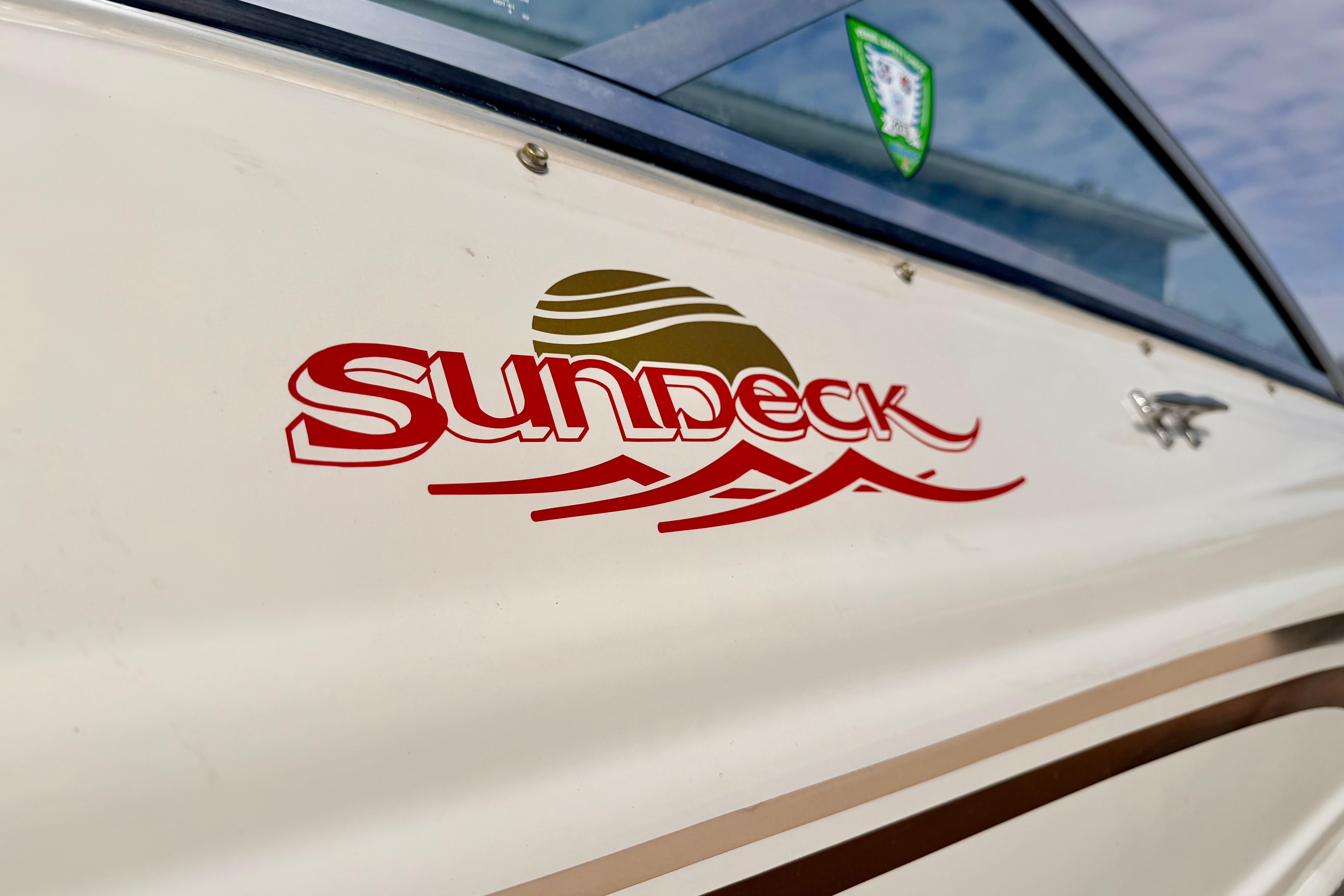 Close-up of 2003 Sea Ray 200 Sundeck boat logo on the side.