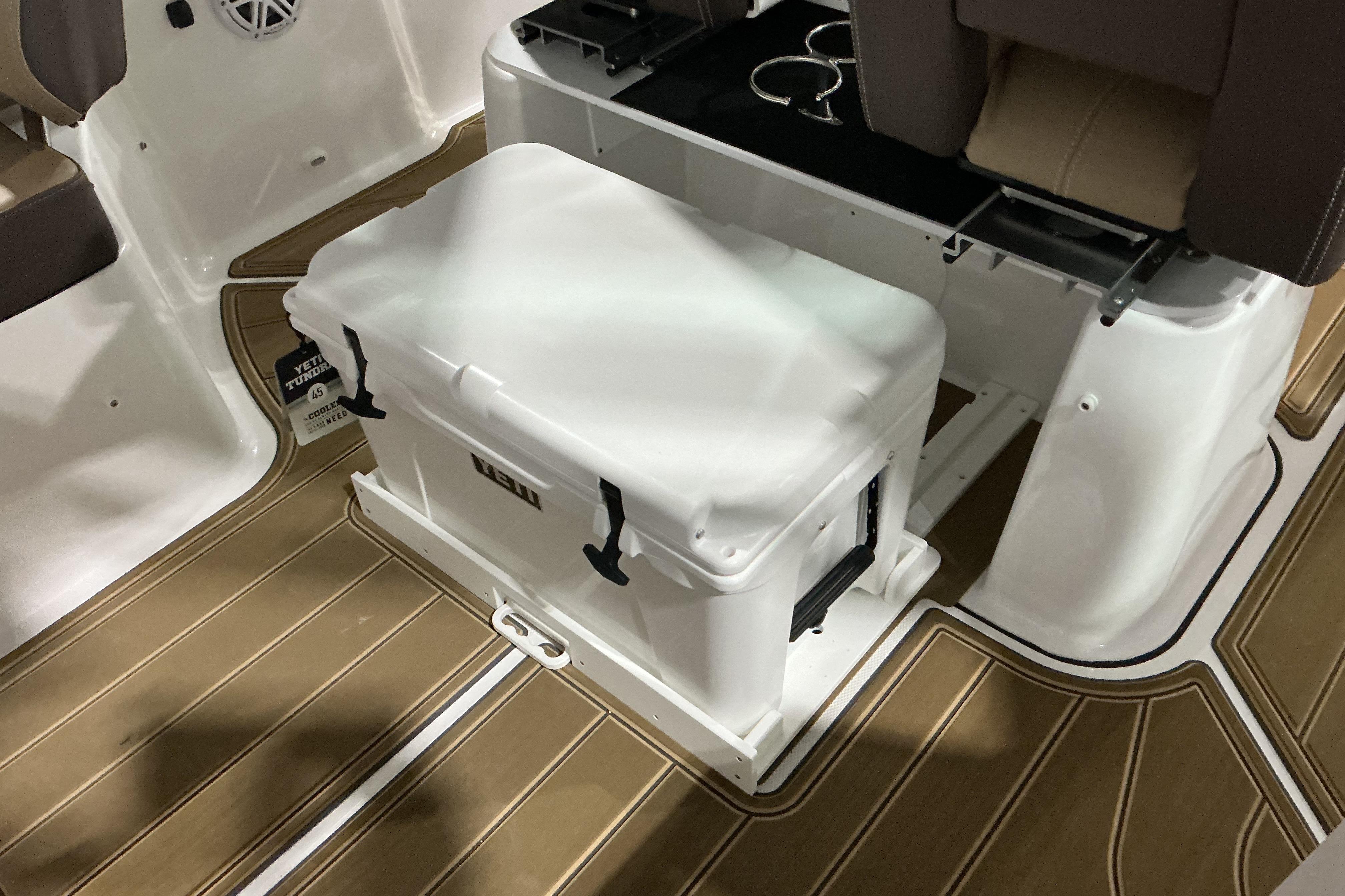 2026 Monterey Elite 25 OB boat interior with Yeti cooler on brown deck.
