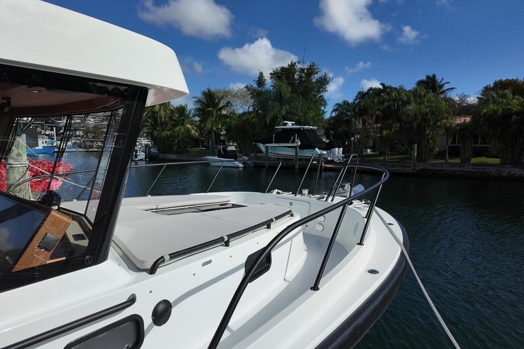 2026 Targa 41 boat docked in a scenic marina under a clear blue sky.