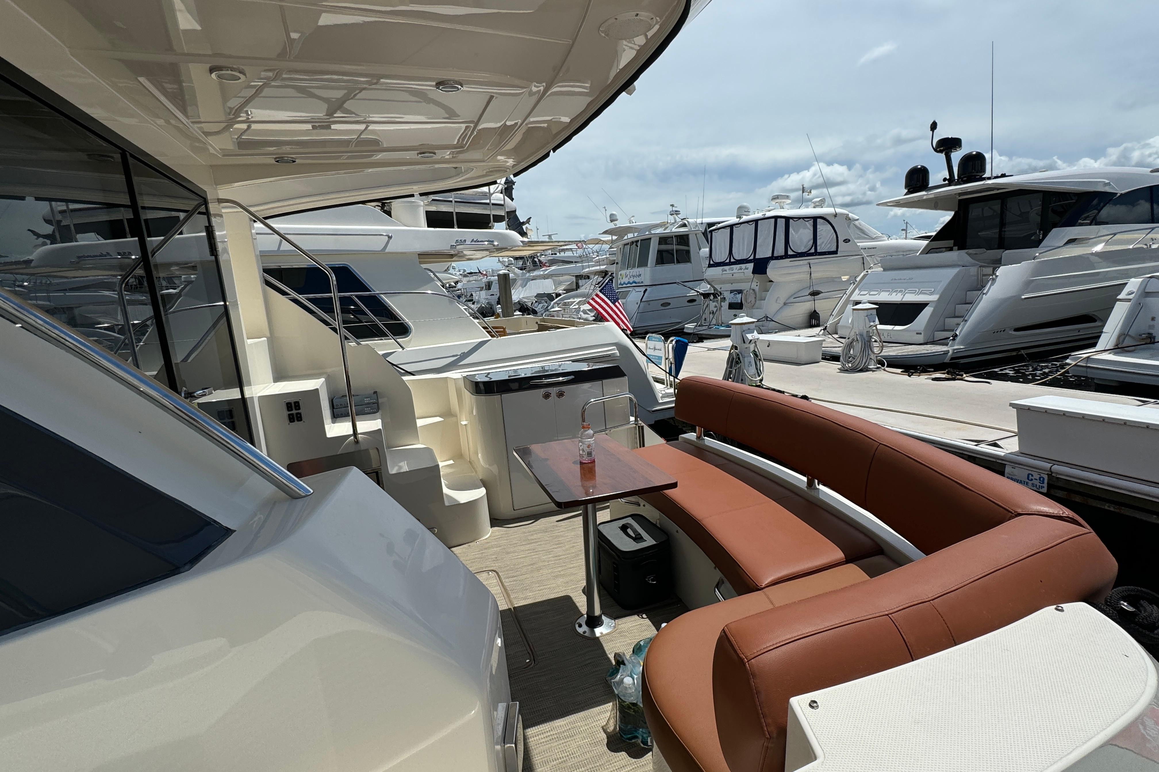 2017 Carver C40 Command Bridge yacht with outdoor seating at a marina.