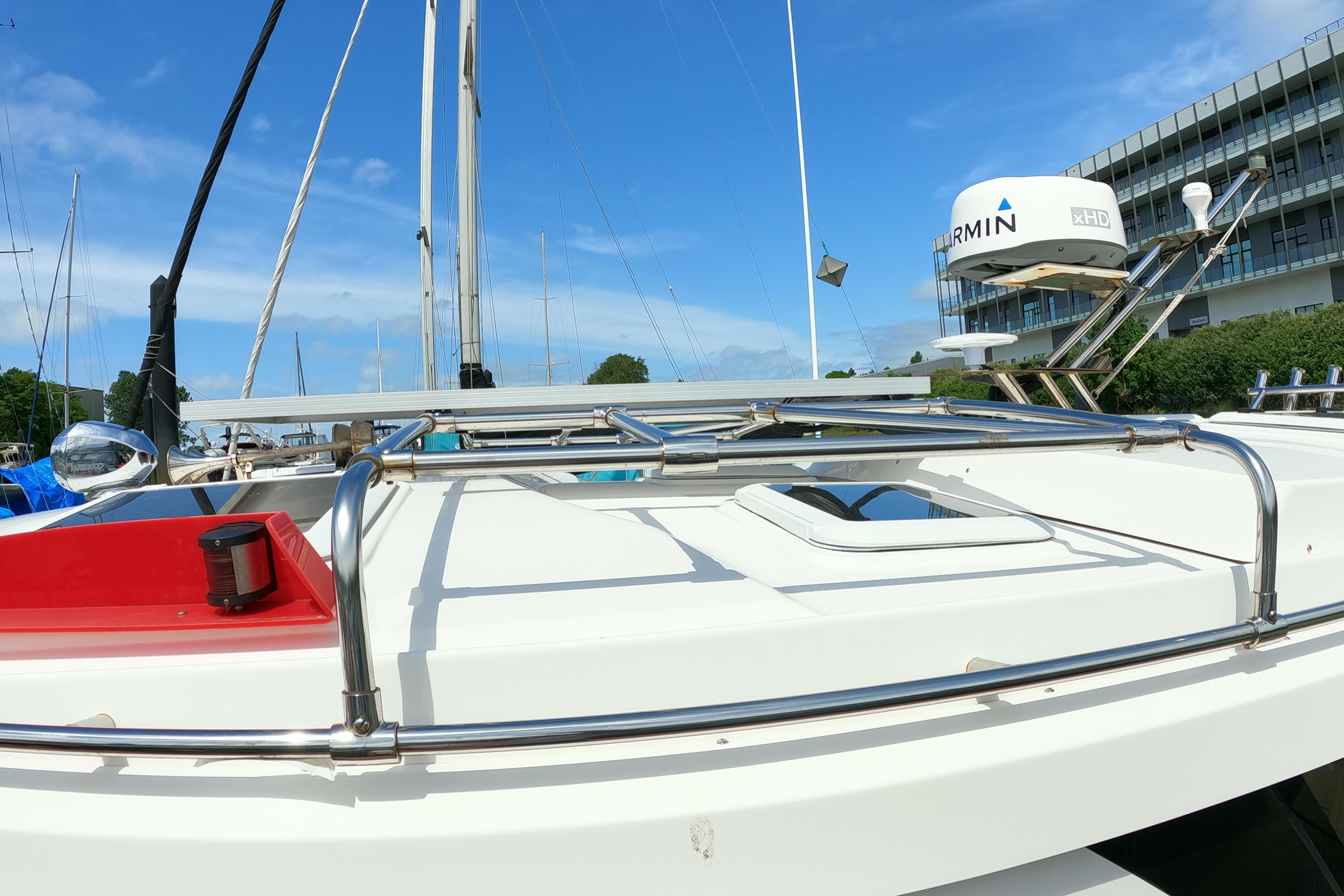 2019 Cutwater C-30 Sedan boat deck with Garmin radar, docked near modern building.