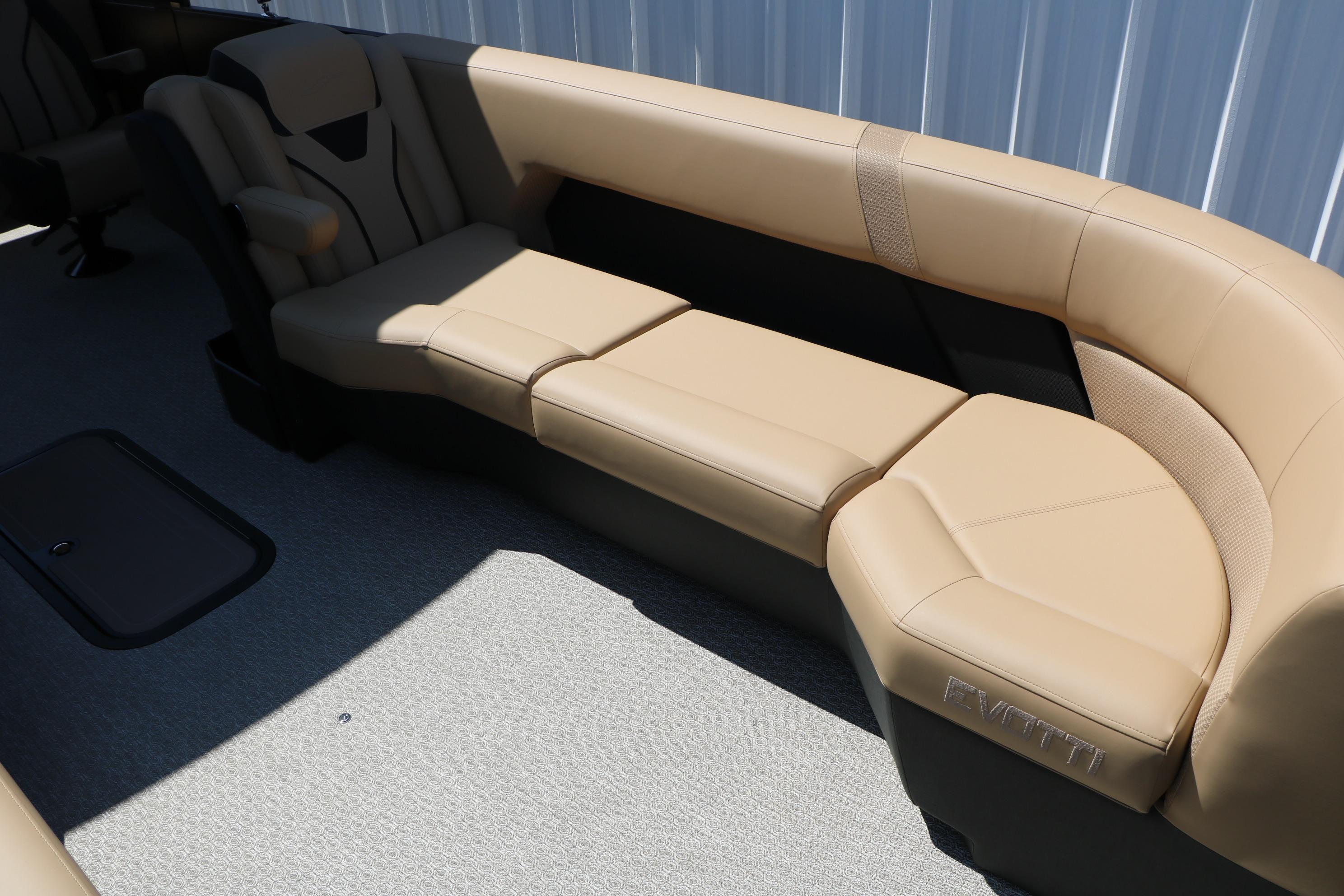 Luxurious seating on 2026 Evotti 725 CS Tri-Toon boat, featuring beige upholstery and modern design.