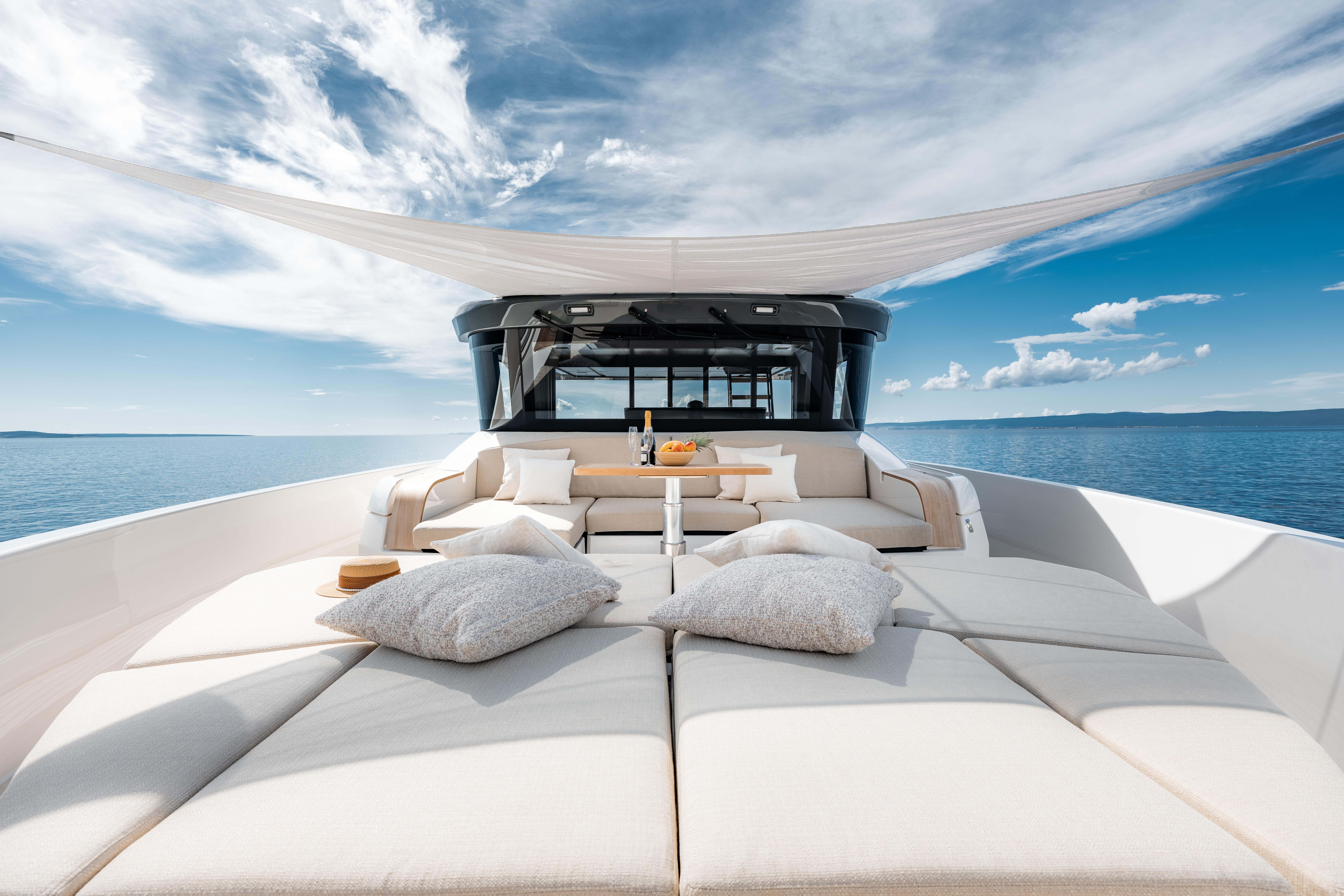 Luxurious 2025 Bluegame BG74 yacht with spacious sun deck and elegant seating on open sea.