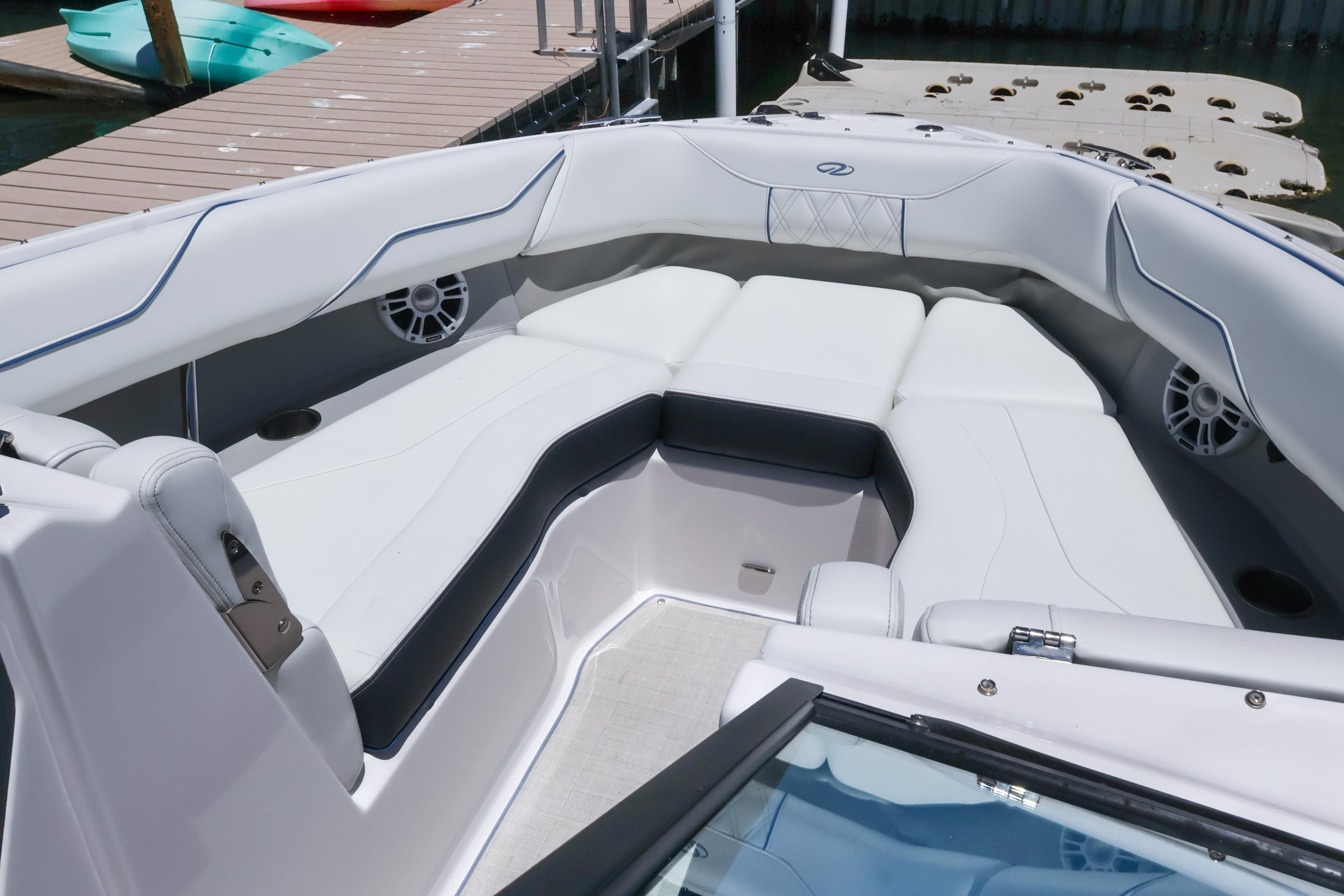 Luxurious seating area on a 2020 Regal LX4 boat, docked by the water.