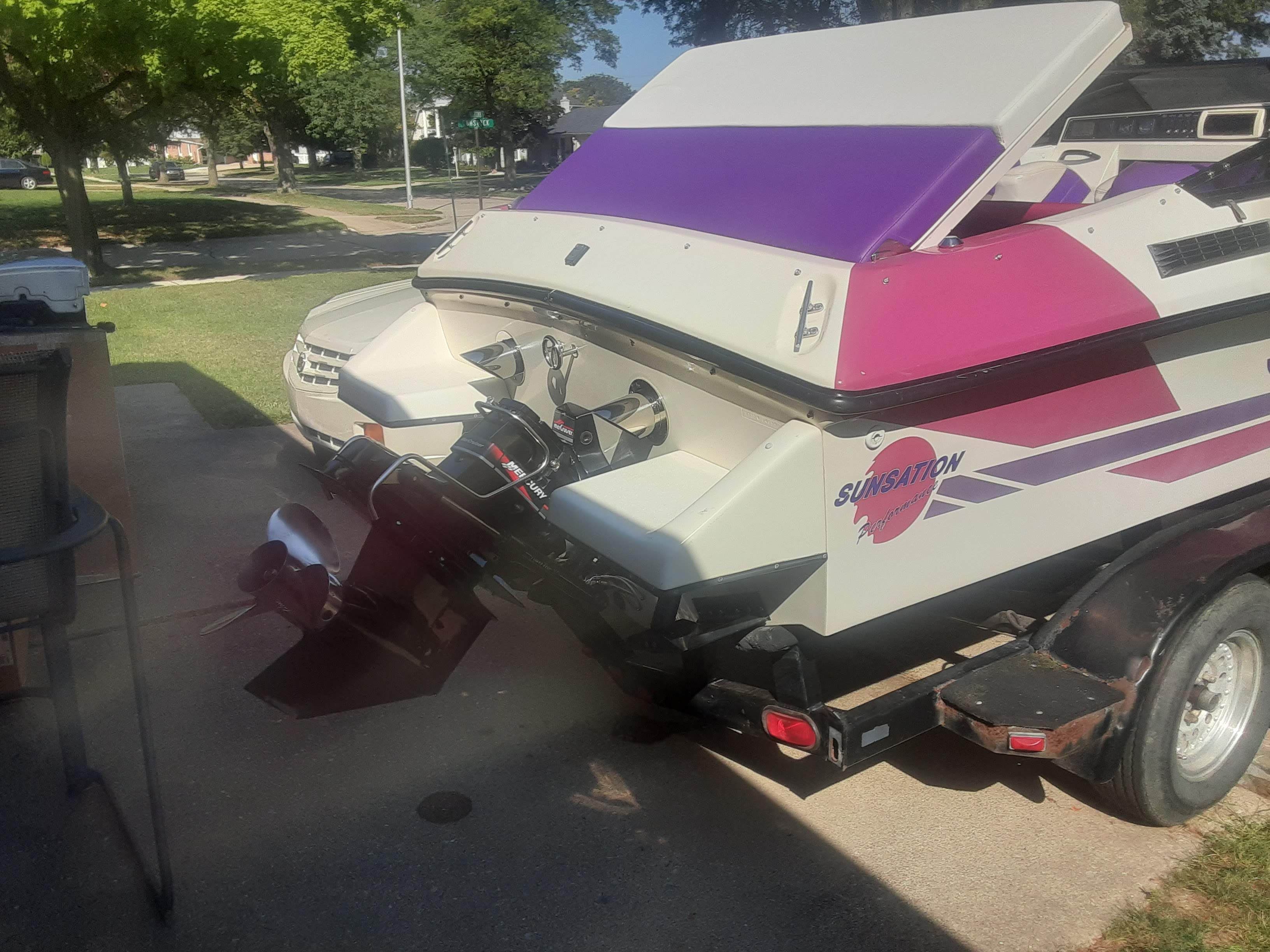 1993 Sunsation Aggressor boat parked on trailer outdoors.