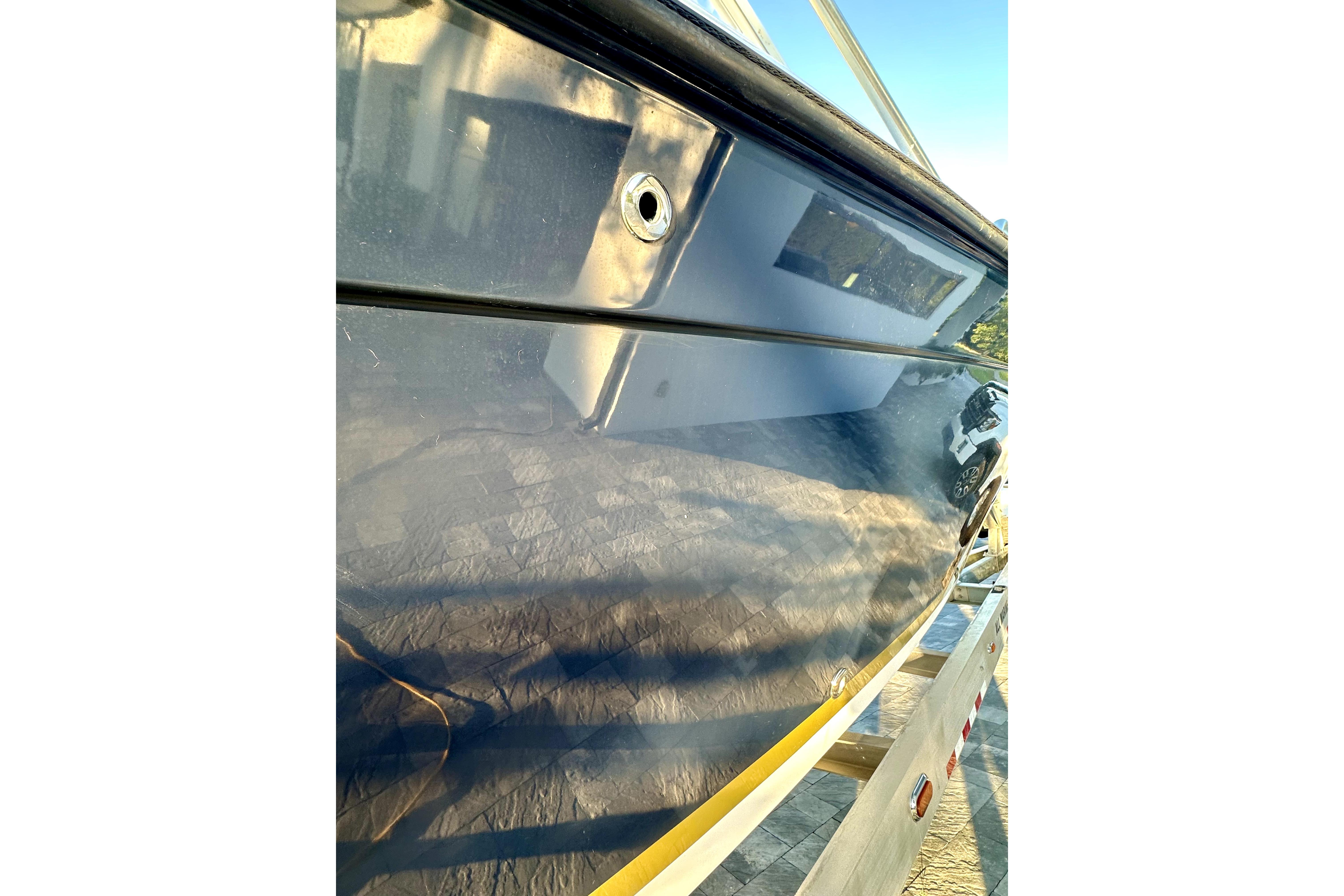 2006 Contender 35 Express Side Console boat hull, reflecting surroundings.