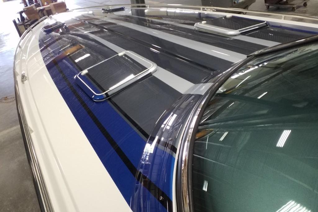 2019 Formula 382 FASTech boat with sleek blue and gray stripes in a showroom.