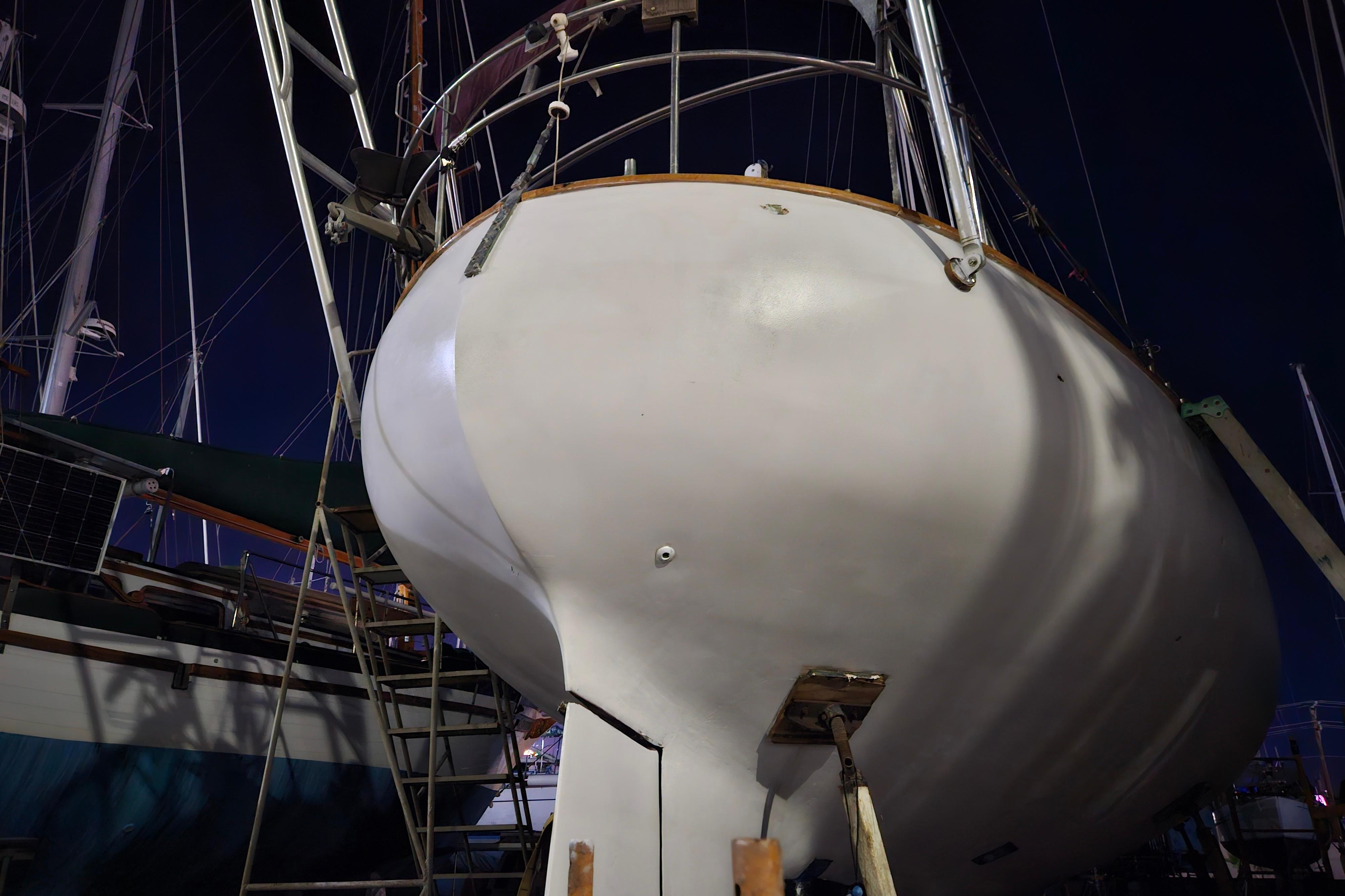 1979 Valiant 40 sailboat in dry dock at night, viewed from stern.