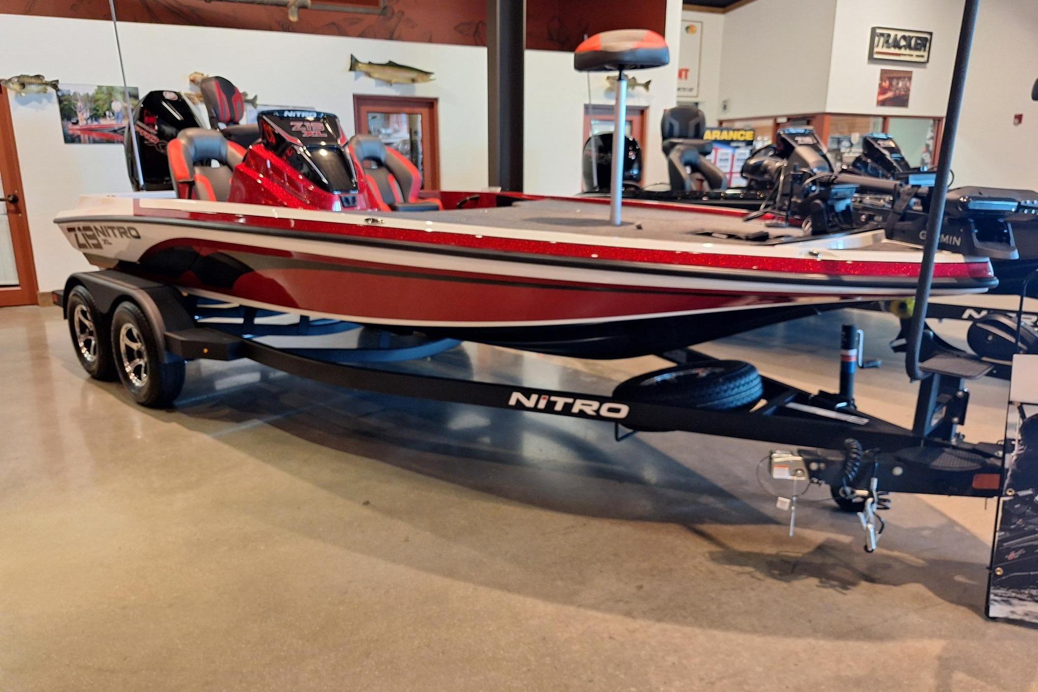 2026 Nitro Z19 XL Pro boat in showroom, red and white design, on trailer.
