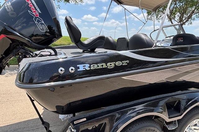 2026 Ranger 212LS boat with sleek black design and powerful engine, parked outdoors.