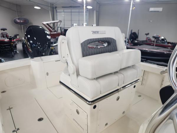 2025 Pathfinder 2400 Open boat interior with cushioned seating in a showroom.