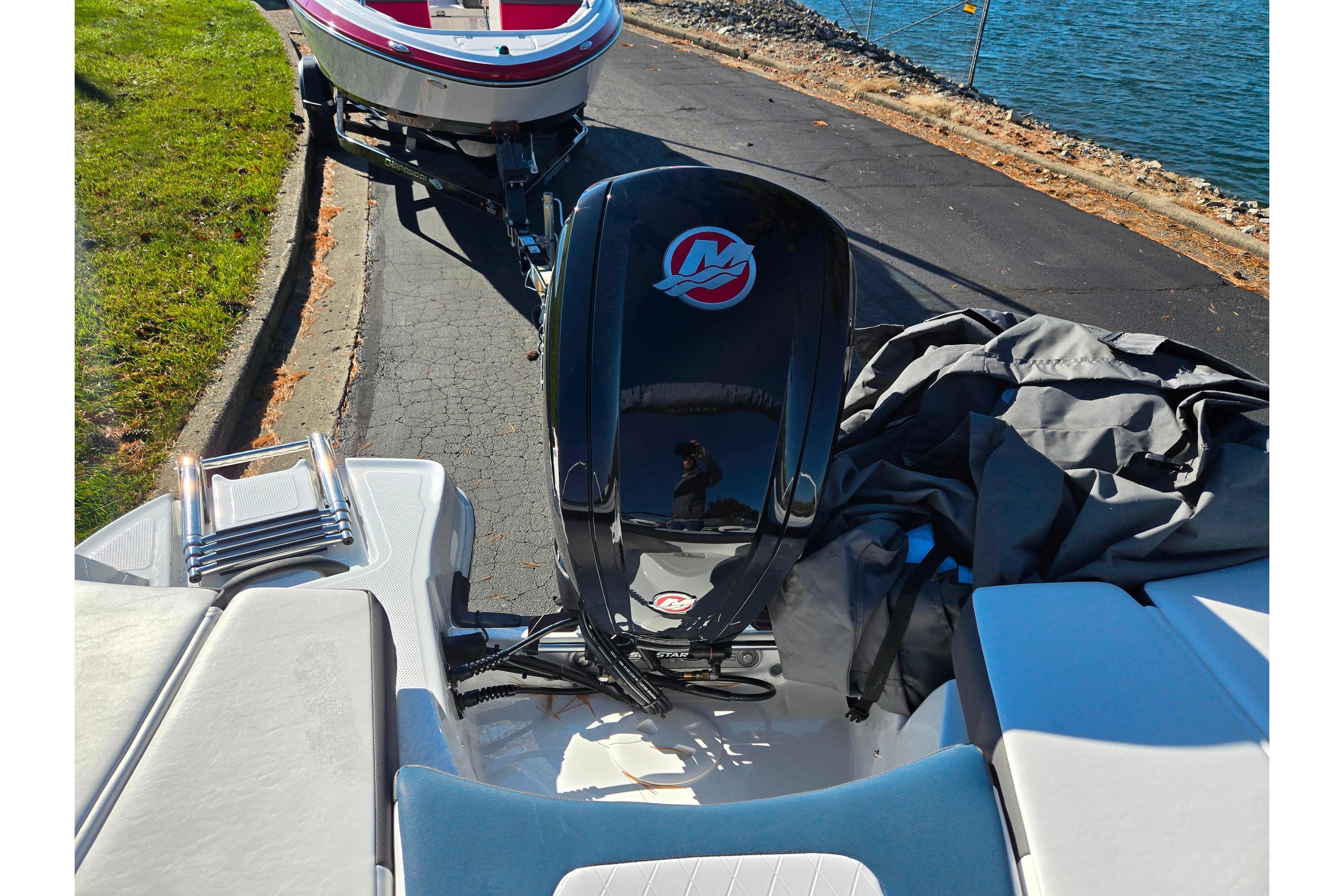 2023 Tahoe 185 S boat with outboard motor near a lake.