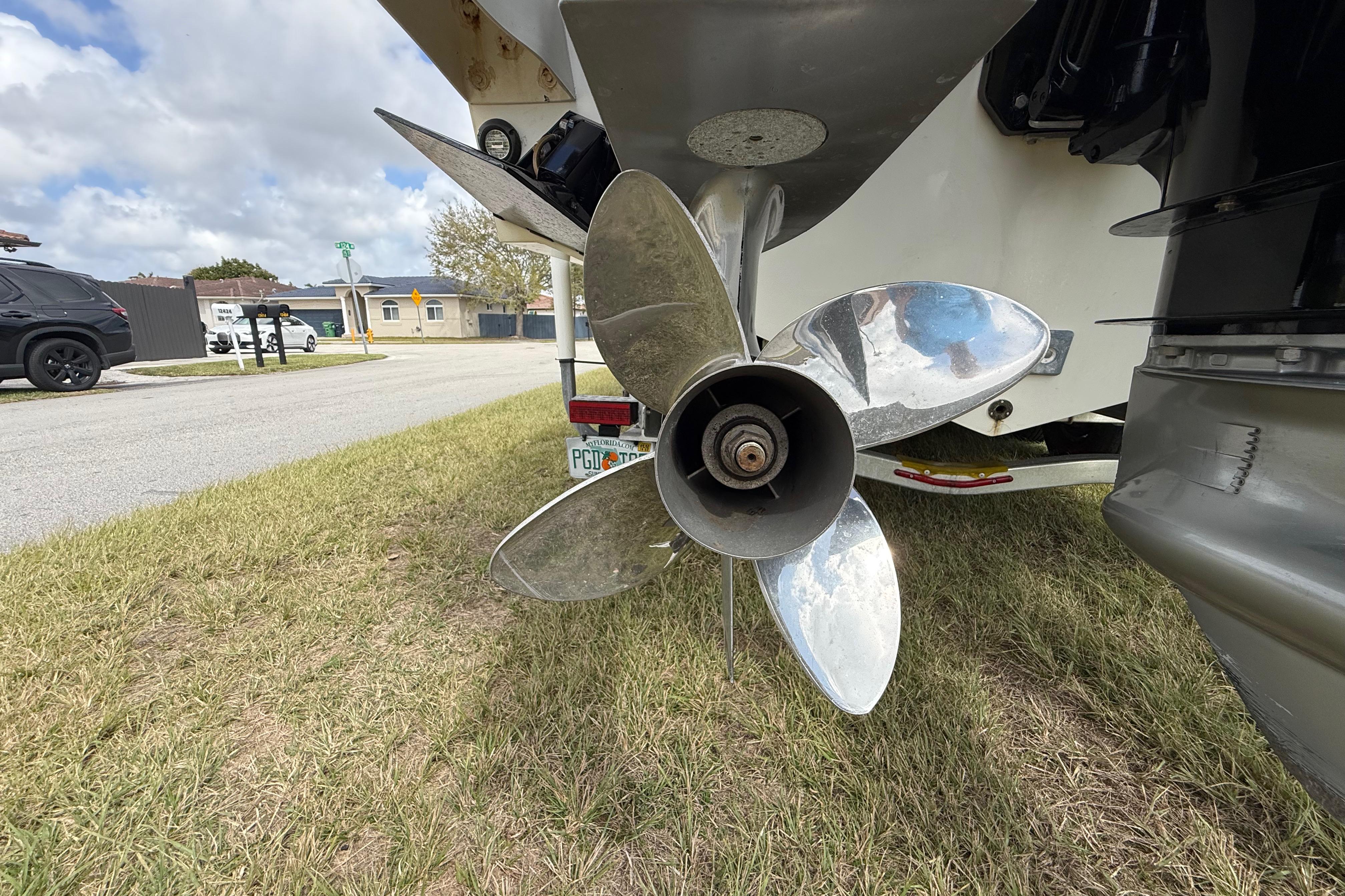 Propeller of 2016 Extreme Boats XC 38 Express on grass, showcasing its polished blades.