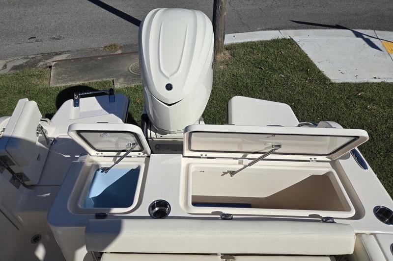 2026 Grady-White Freedom 235 boat with open storage compartments and outboard motor.