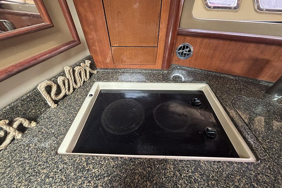 2006 Sea Ray 44 Sundancer kitchen with stove and "Relax" decor.