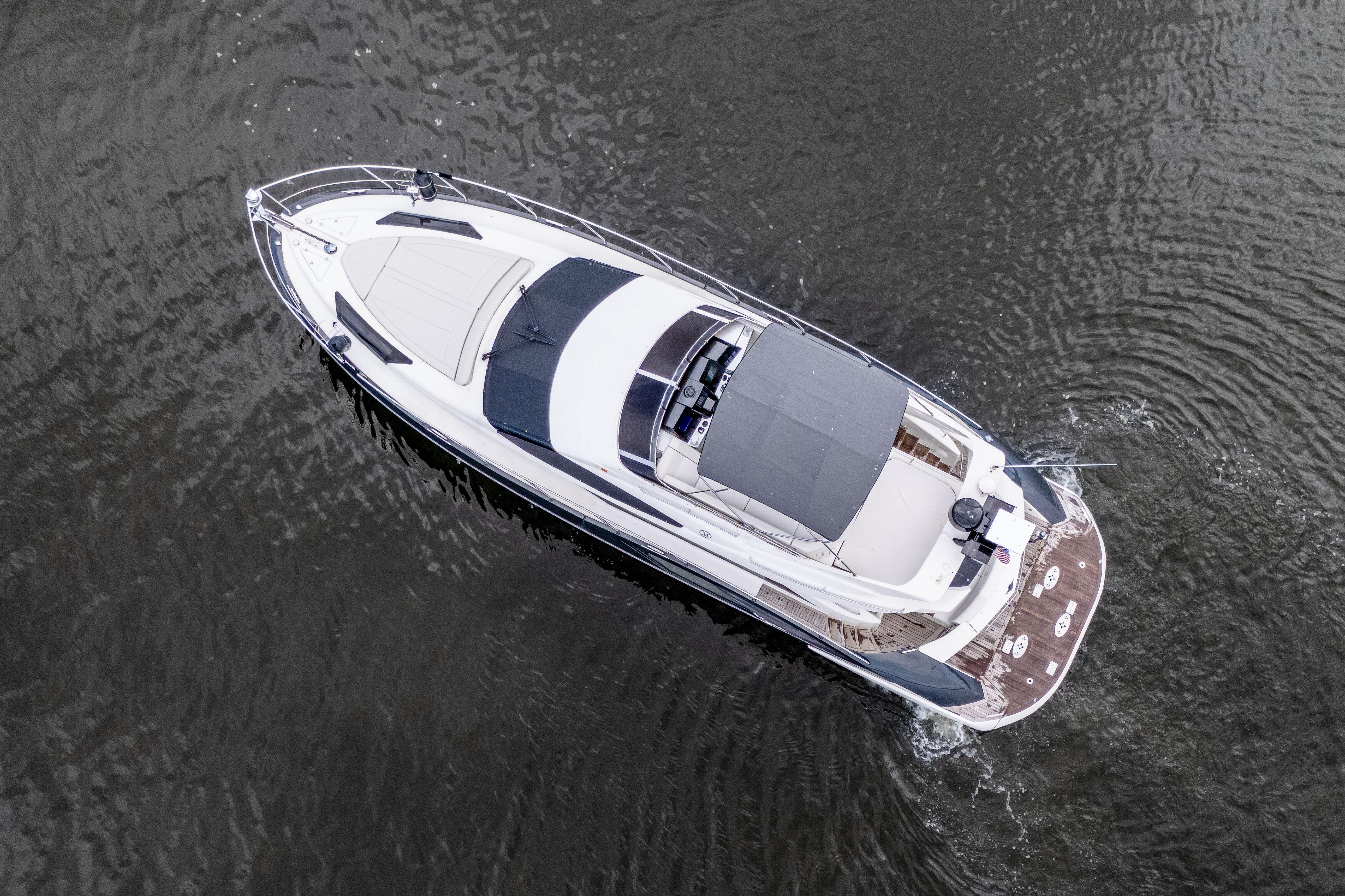 Aerial view of 2009 Marquis 500 Sport Bridge yacht cruising on water.