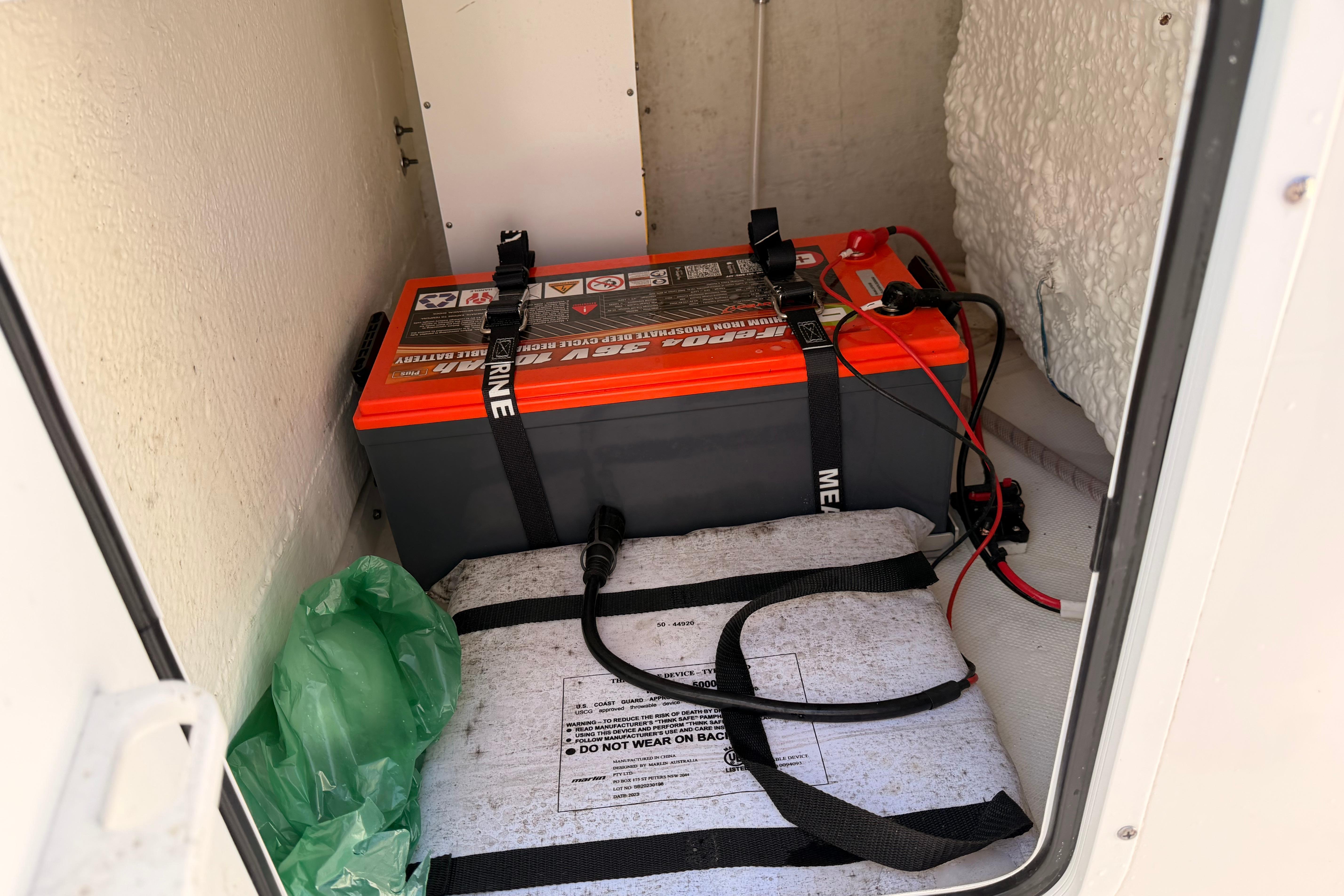 2024 Sea Hunt Gamefish 27 Coffin Box battery compartment with secured marine battery.