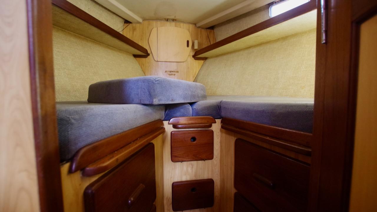 1981 Morgan Out Island 41 cabin interior with wooden storage and cushioned seating.