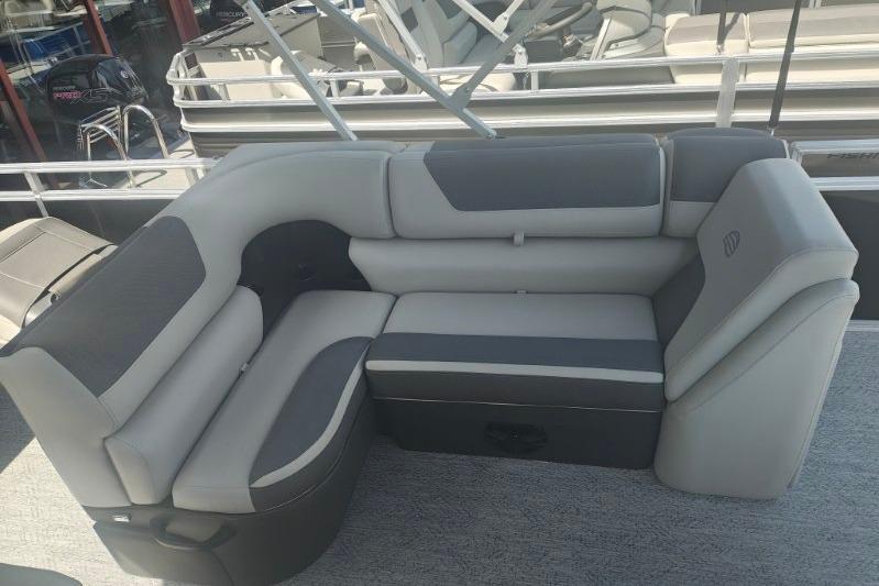 2026 Sun Tracker Fishin' Barge 20 DLX pontoon boat seating area, featuring gray upholstery.