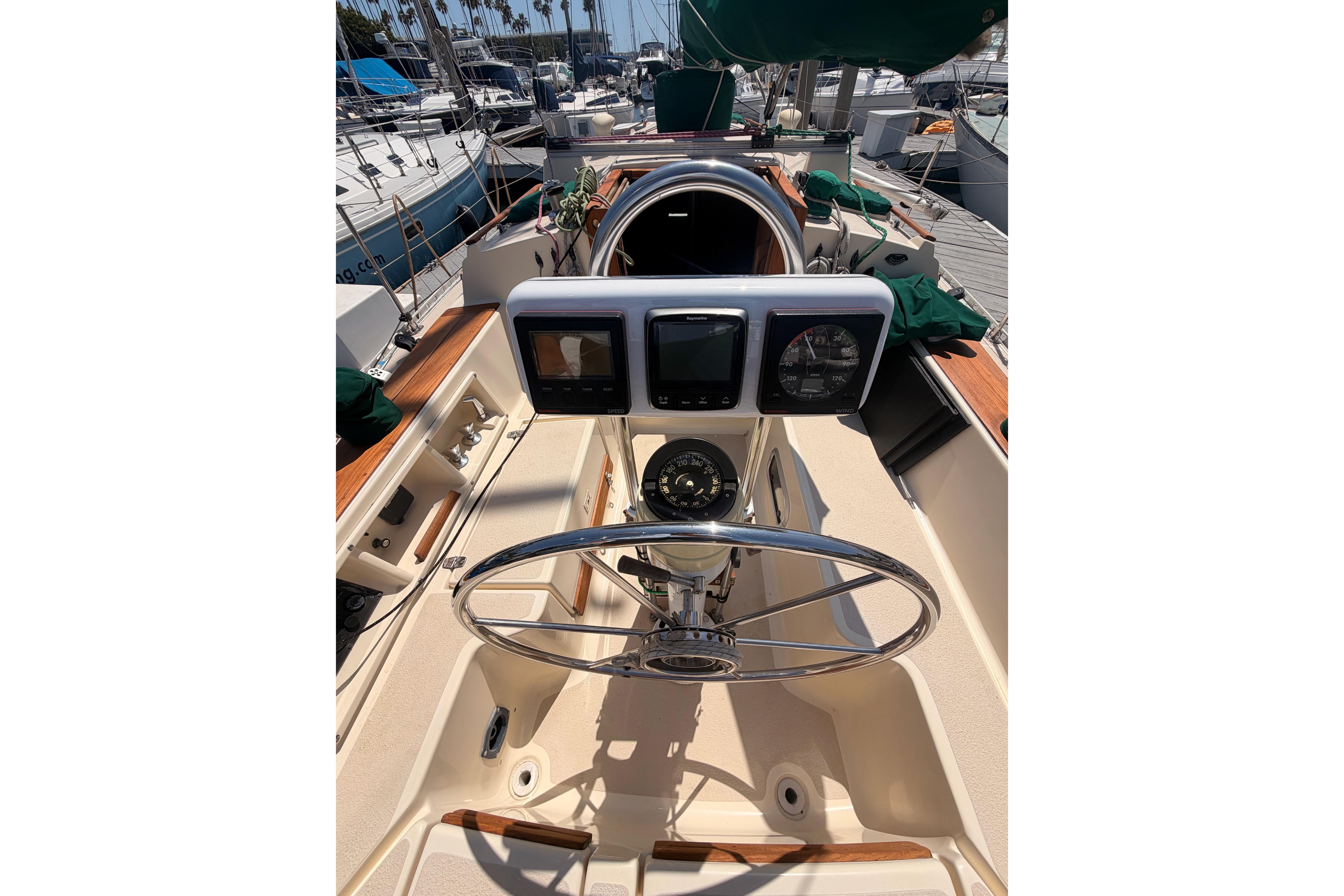 Cockpit of 1991 Caliber 33 sailboat with steering wheel and navigation instruments.
