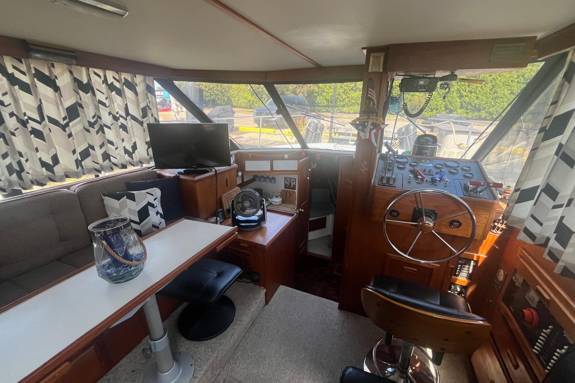 Interior of 1990 Cooper Prowler 35 boat with helm, seating, and decor.