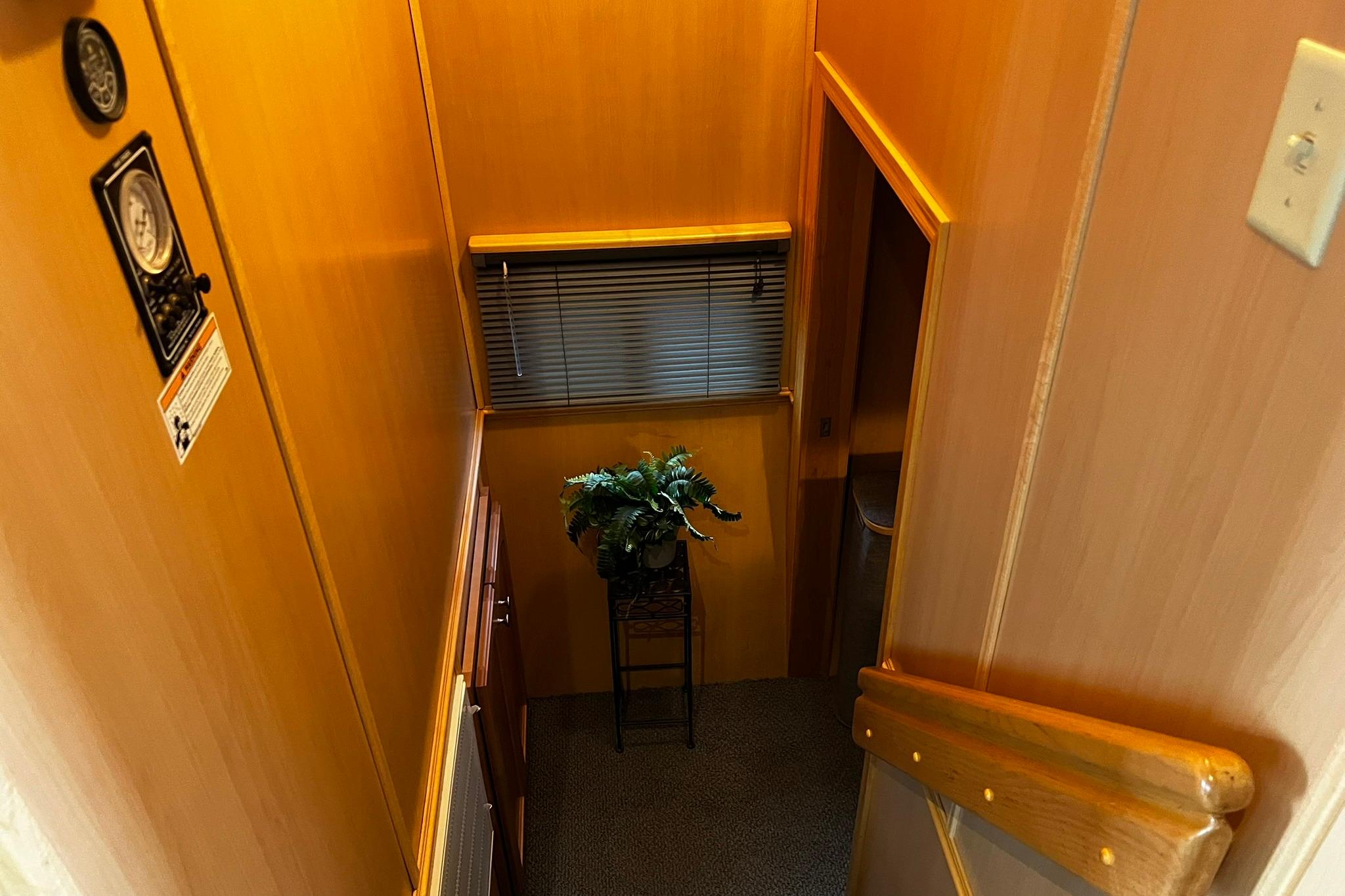Interior of 2010 Skipperliner 480 Flybridge with wooden walls and decorative plant.