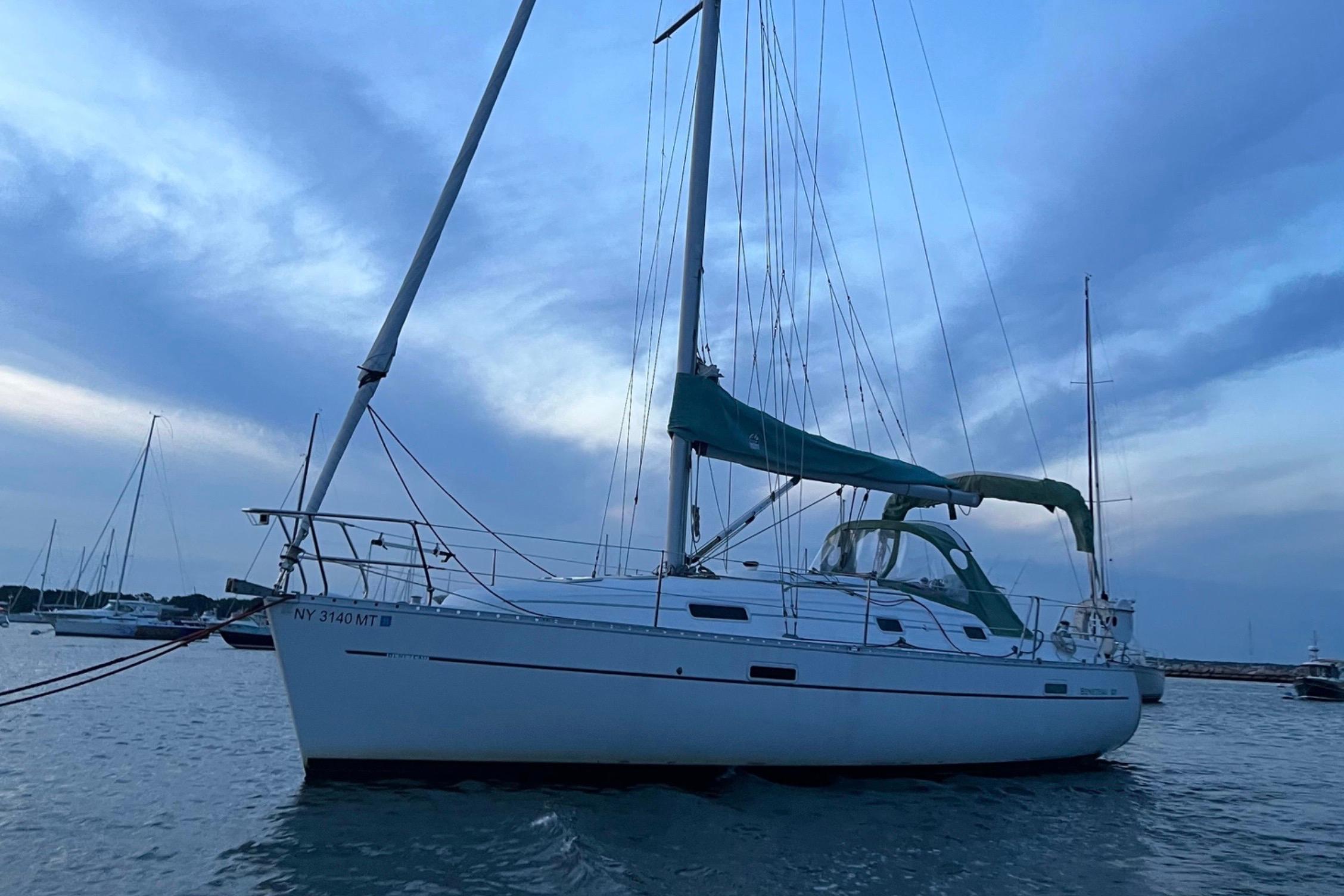 Sailboat Beneteau 331, 2001 model, anchored at dusk with a serene sky backdrop.