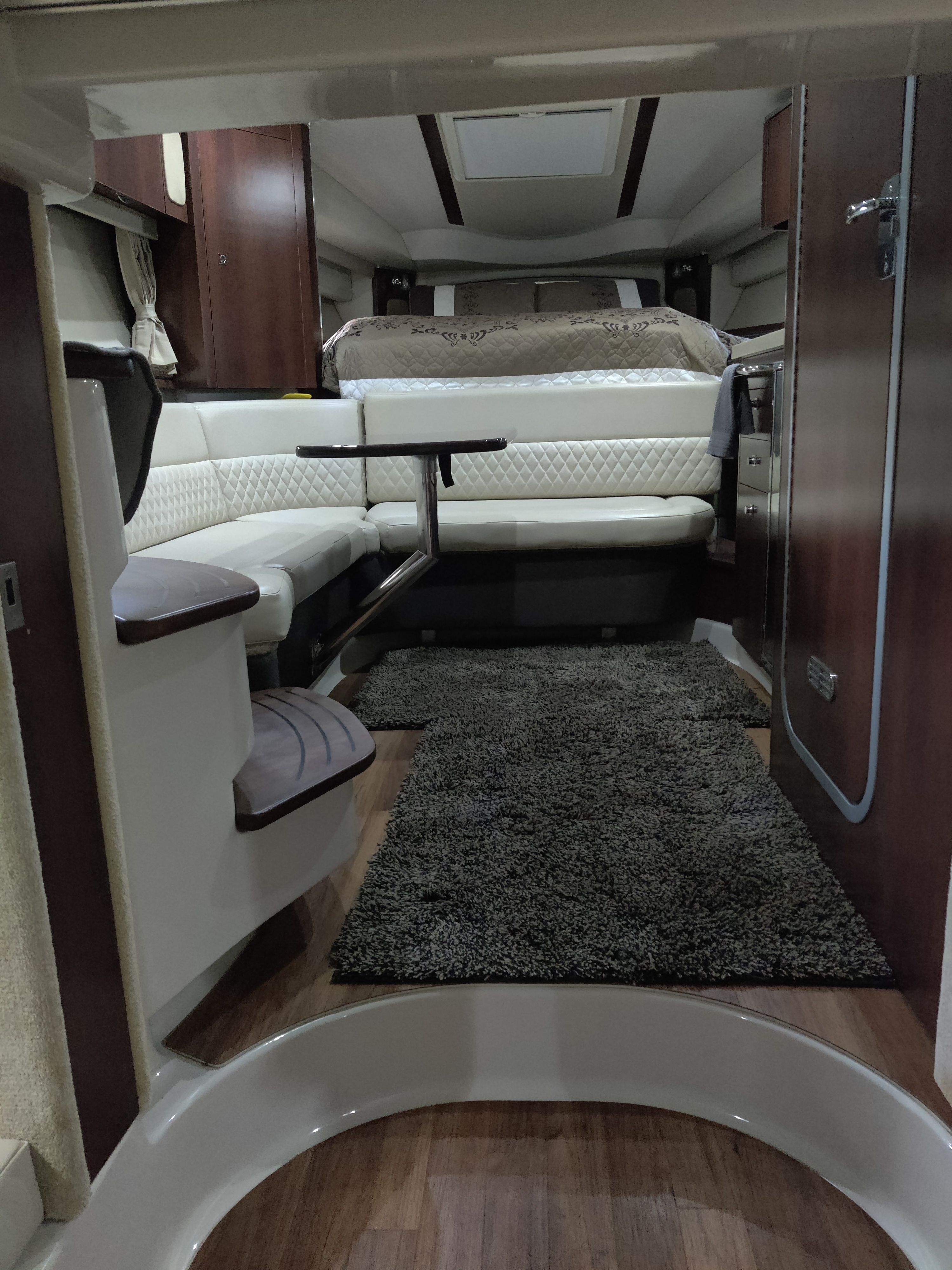 Interior of a 2014 Chaparral 330 Signature boat with cozy seating area.