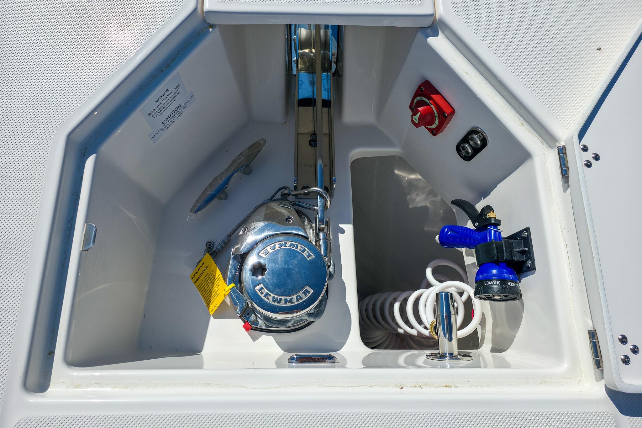 Anchor compartment of 2026 Regal 38 SAV boat with Lewmar windlass and hose.