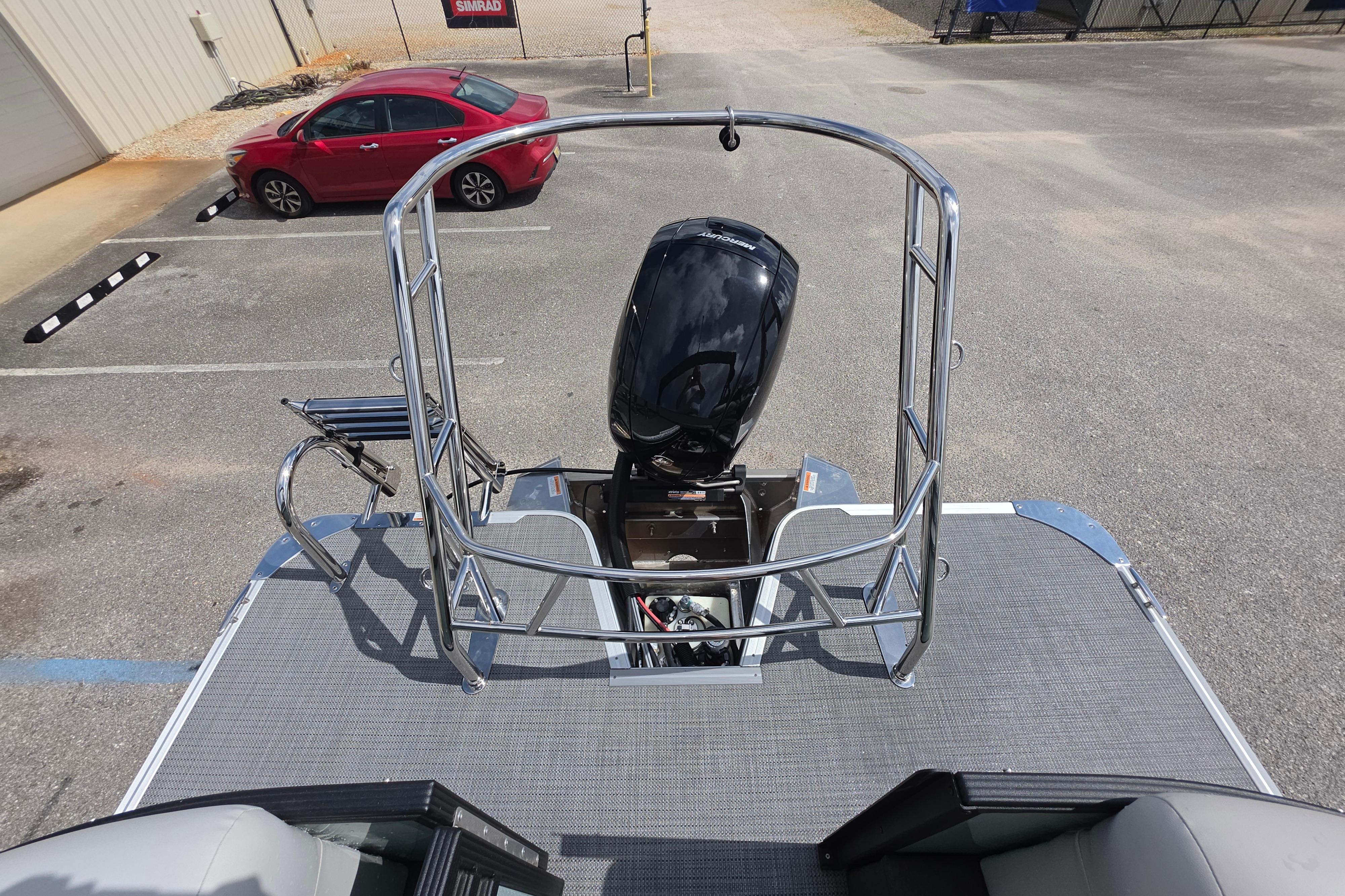 2026 Crest 235 Conquest SLC boat with outboard motor in a parking lot.