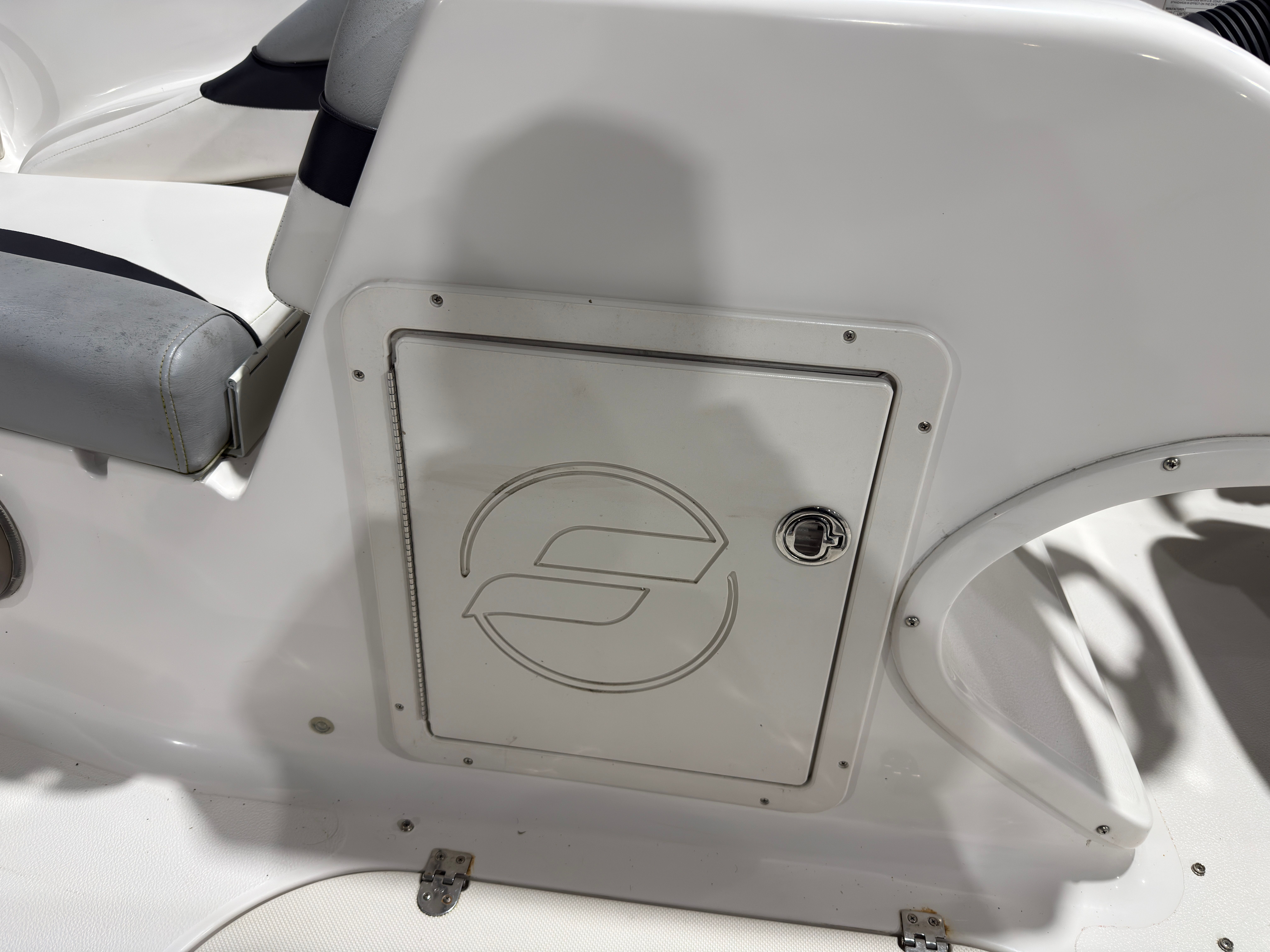 Starcraft 2000 Limited 2014 boat, white seating and storage compartment.