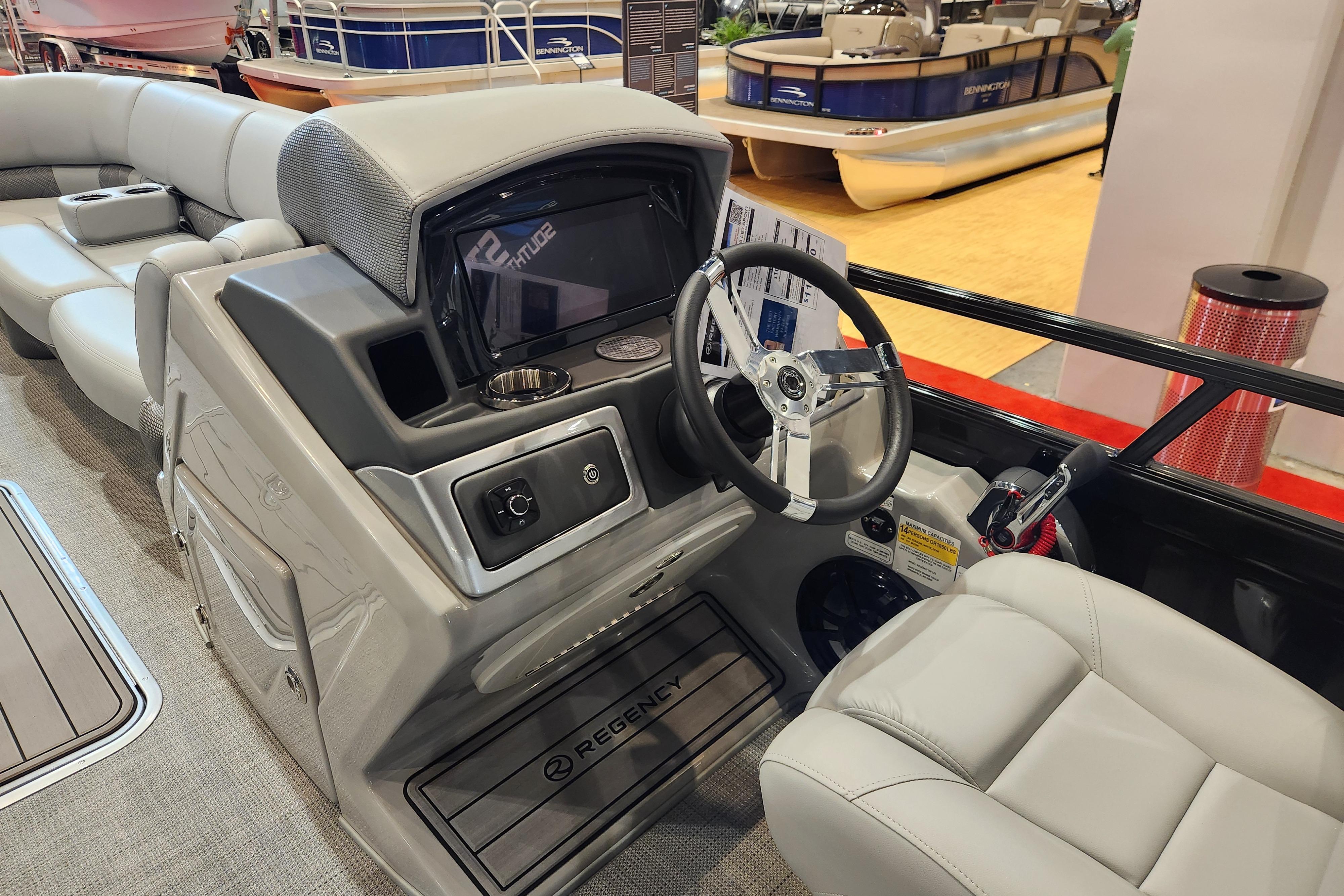 2025 Regency 250 LE3 boat interior with steering wheel and seating.