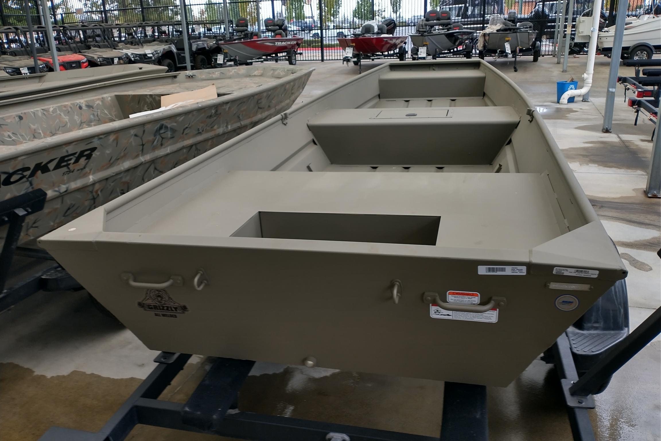 2026 Tracker Grizzly 15 Jon boat displayed in a showroom.