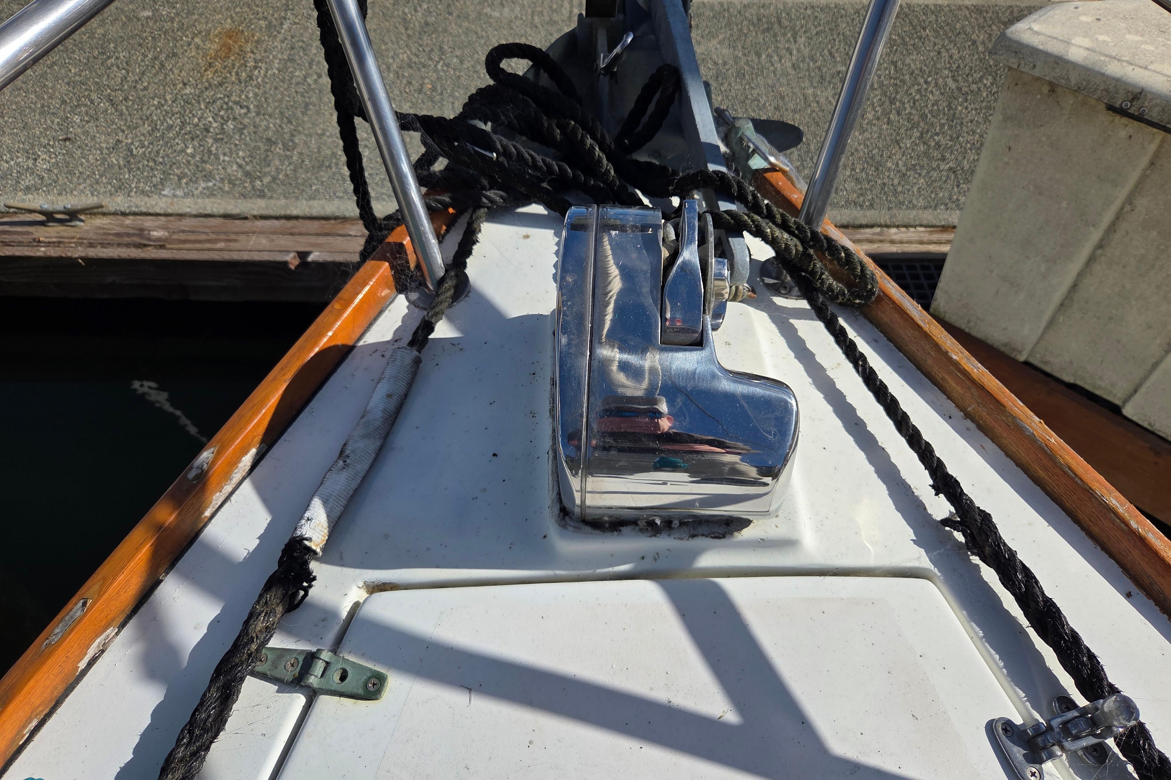 Bow of 1982 Cape Dory 33 sailboat with anchor windlass and ropes.