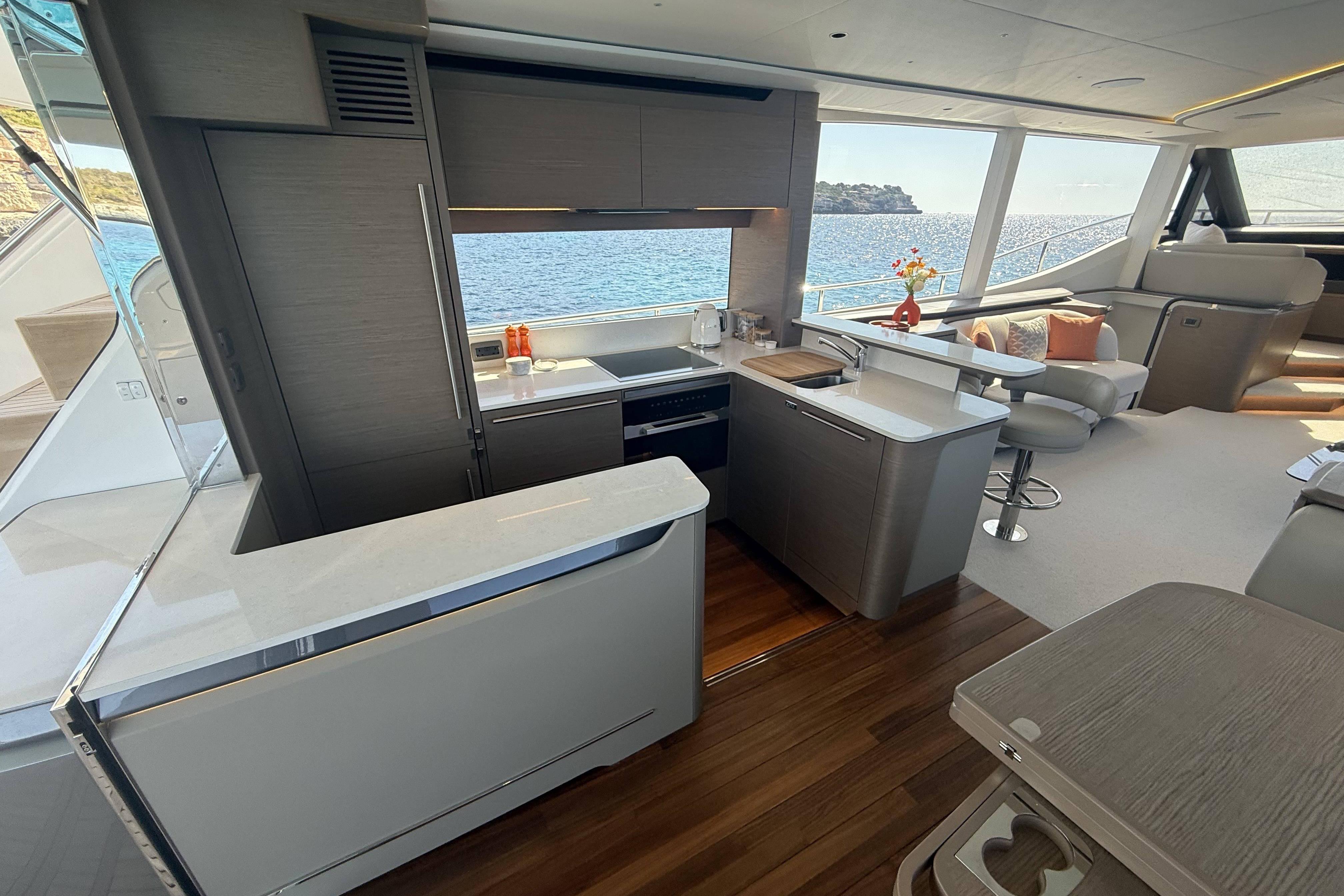 Luxurious 2025 Princess Y72 yacht interior with modern kitchen and ocean view.