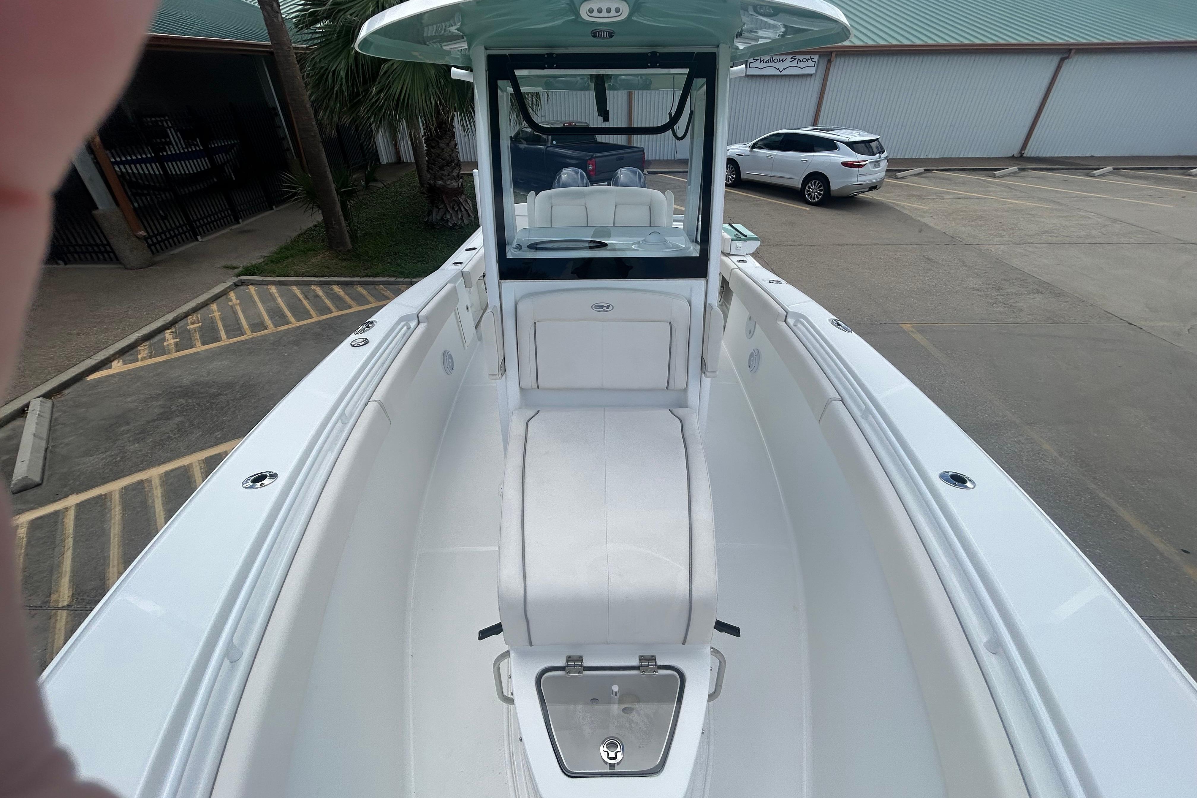 2023 Sea Hunt Gamefish 27 Coffin Box boat, white interior, parked in a lot.