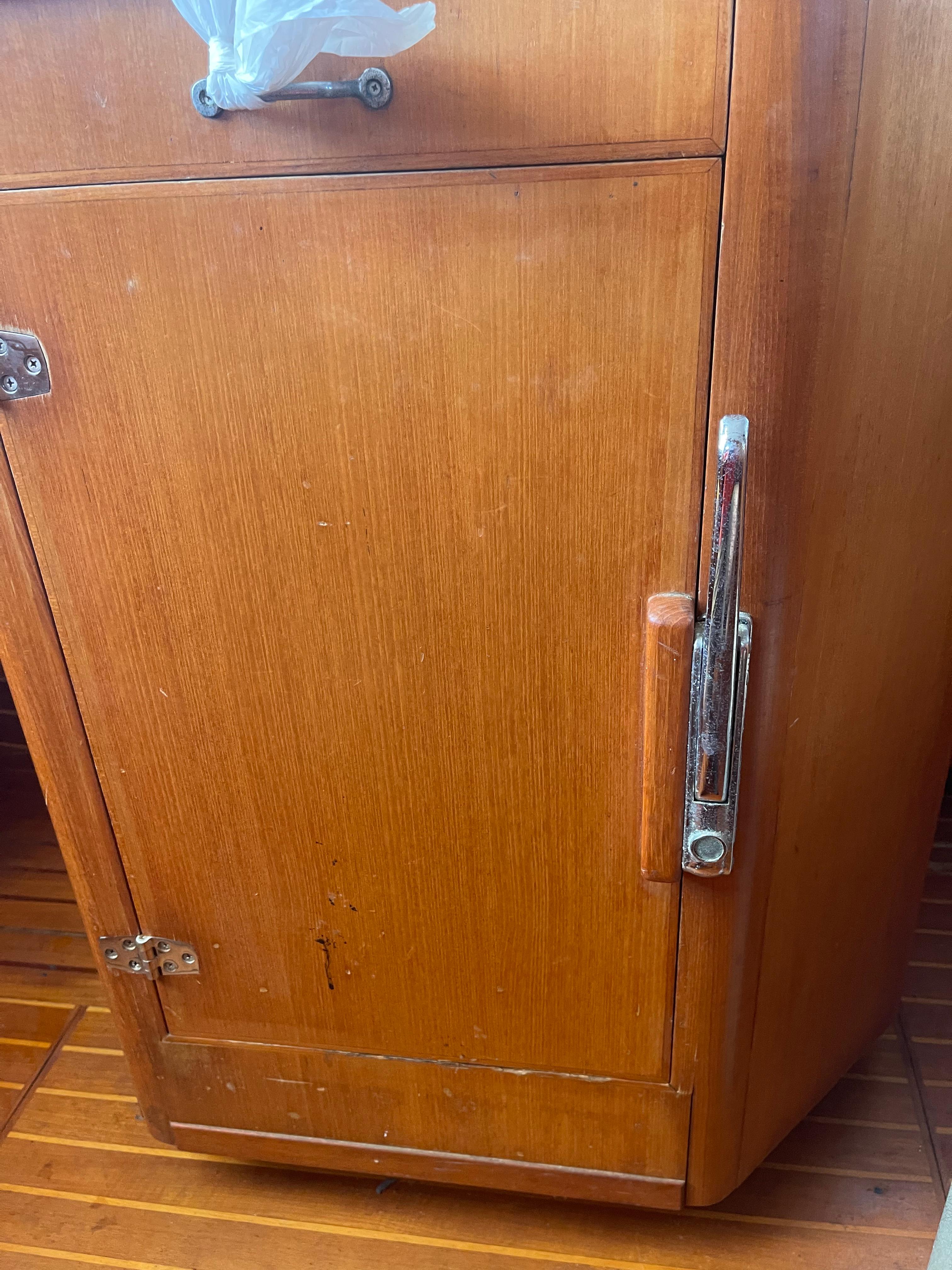 Wooden cabinet door on a 1995 Passport 47 AC Plan B sailboat.