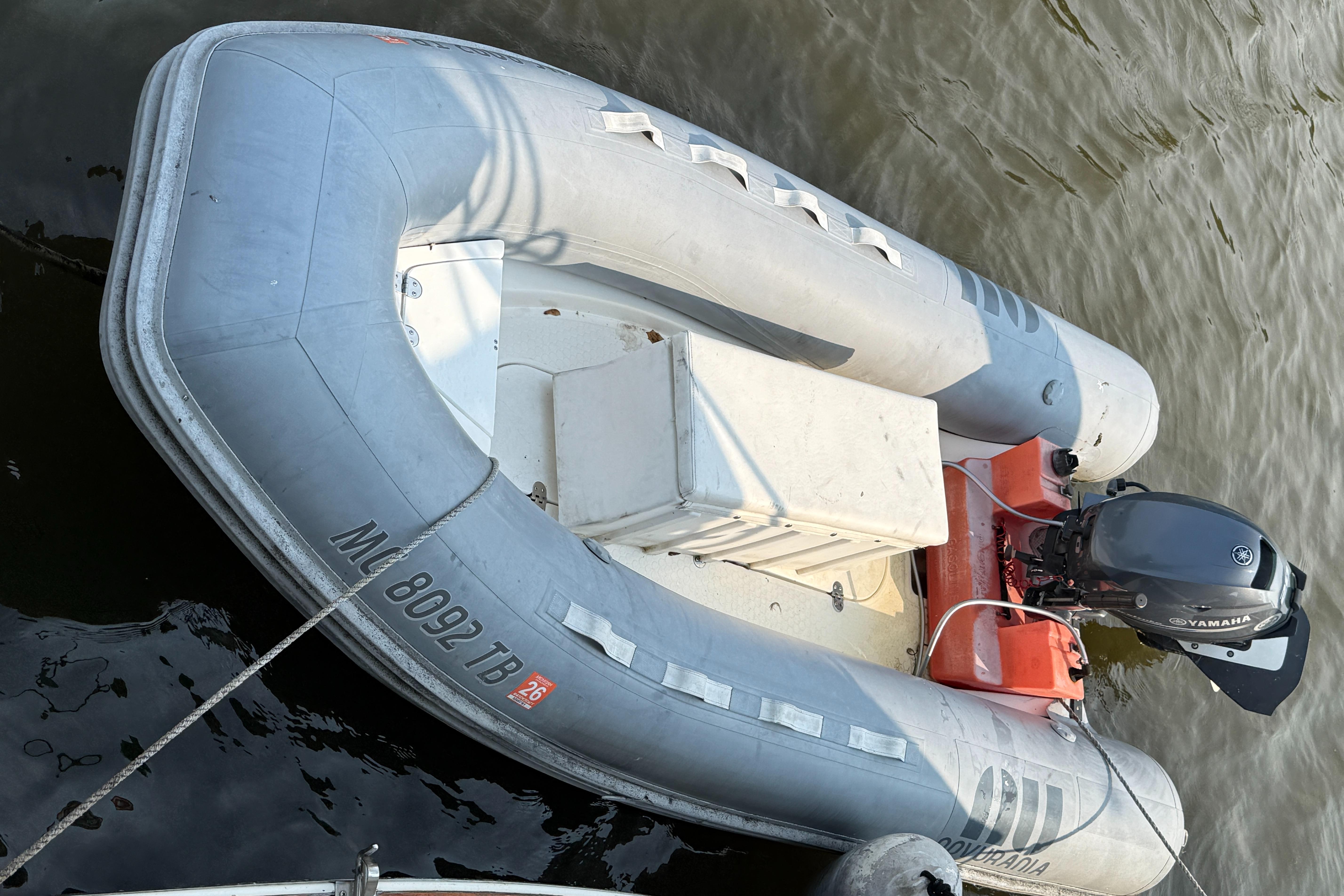 Inflatable boat with Yamaha motor on water, viewed from above.